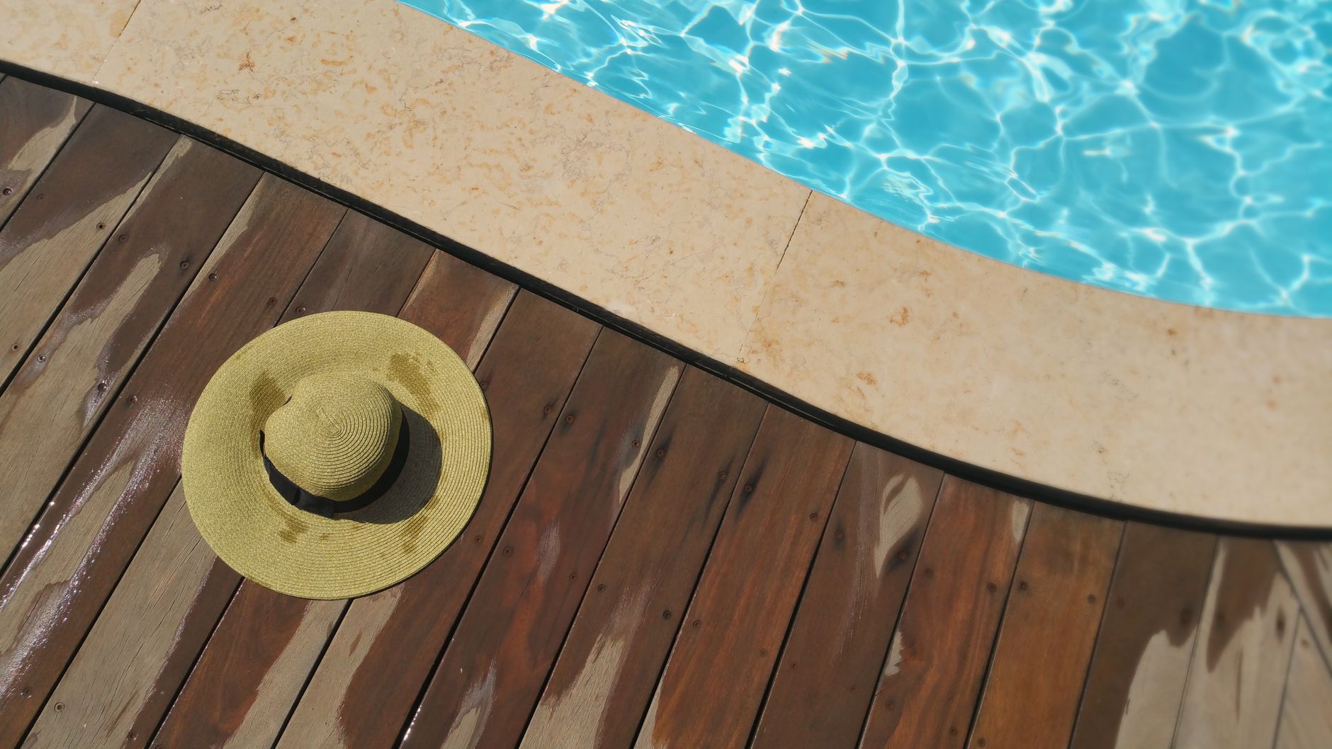 A close view of a wet pool-deck surface and drain, showing the kind of traction and drainage conditions buyers need to evaluate.