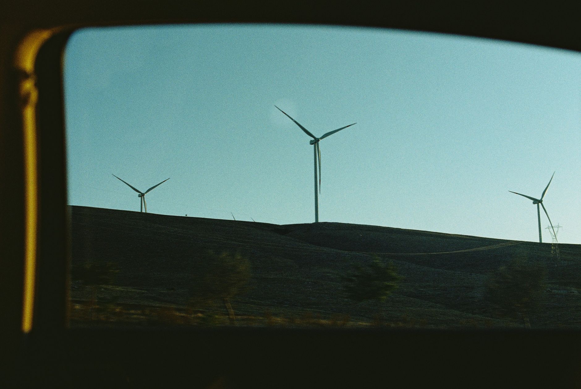 A wind turbine rotor against the sky, illustrating the blade surfaces that RGB and thermal sensors must capture.