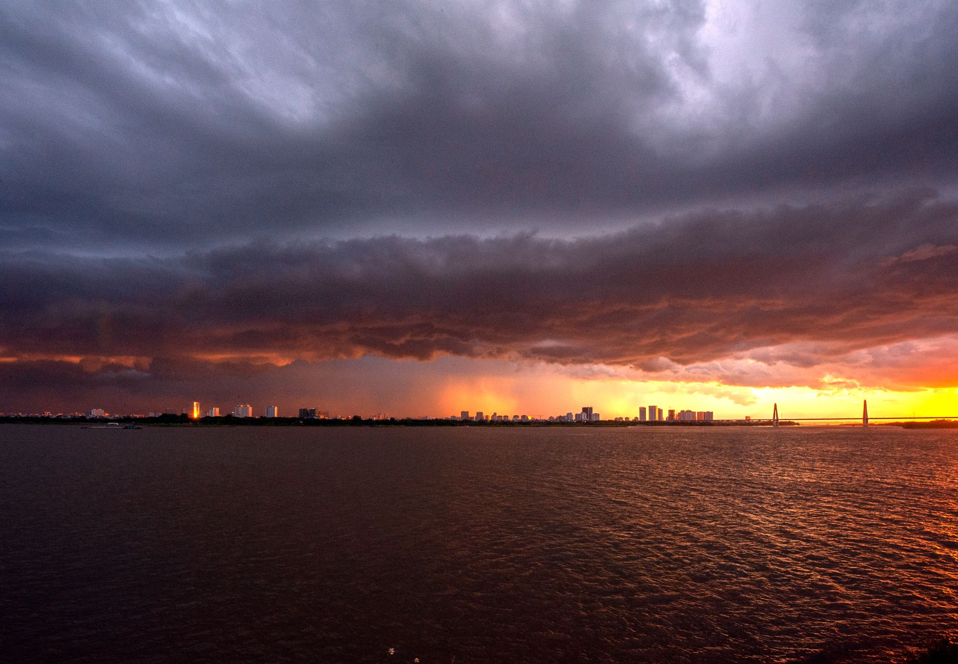 Storm clouds building over open terrain, a visual cue for post-storm blade triage flights.
