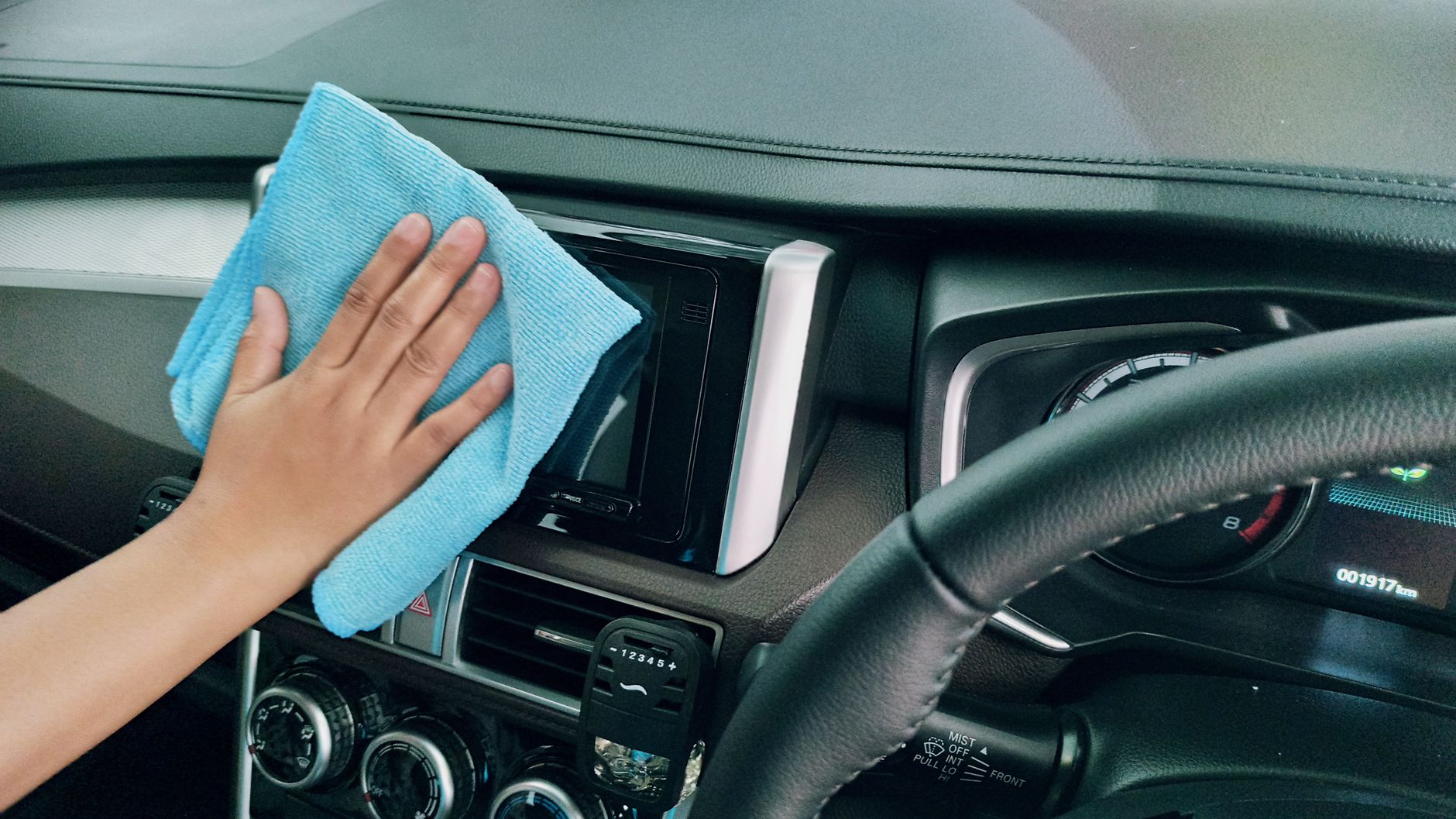 The clean and detailed interior of a modern car, focusing on the dashboard and passenger seat.