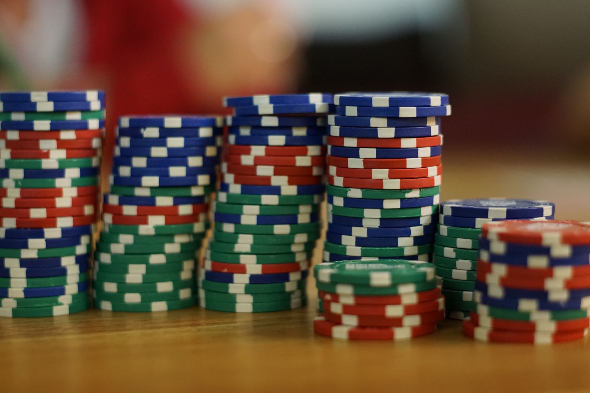 A secure, brightly lit casino count room with stacks of currency and chips being sorted, representing the high-stakes environment of cash handling.