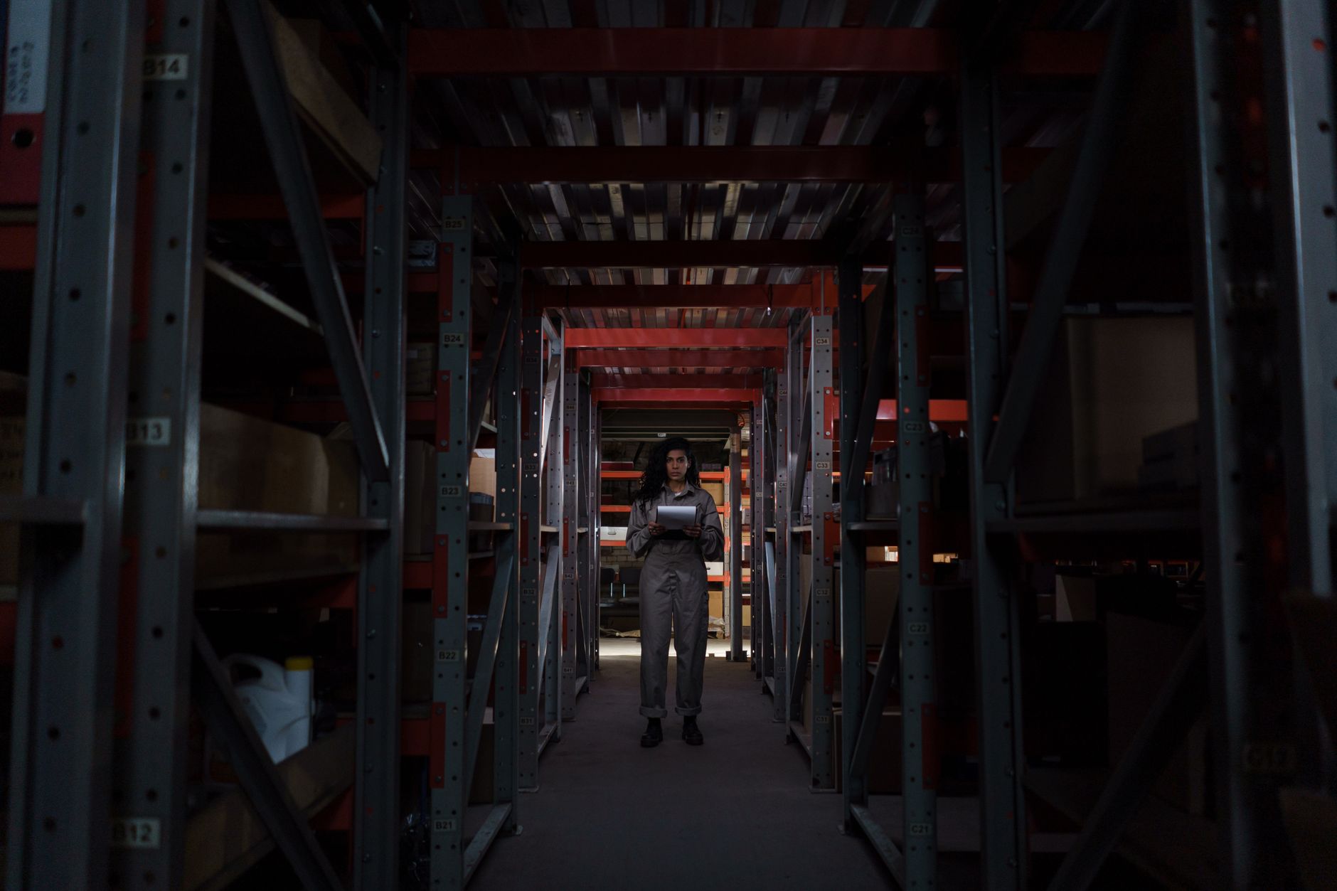 A large, clean warehouse floor at night, illustrating an environment where LiDAR allows robots to work in complete darkness.