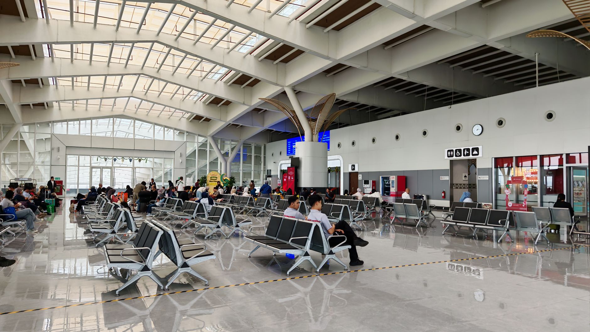 A spacious, modern airport terminal, an example of a complex environment where autonomous mobile robots are deployed.