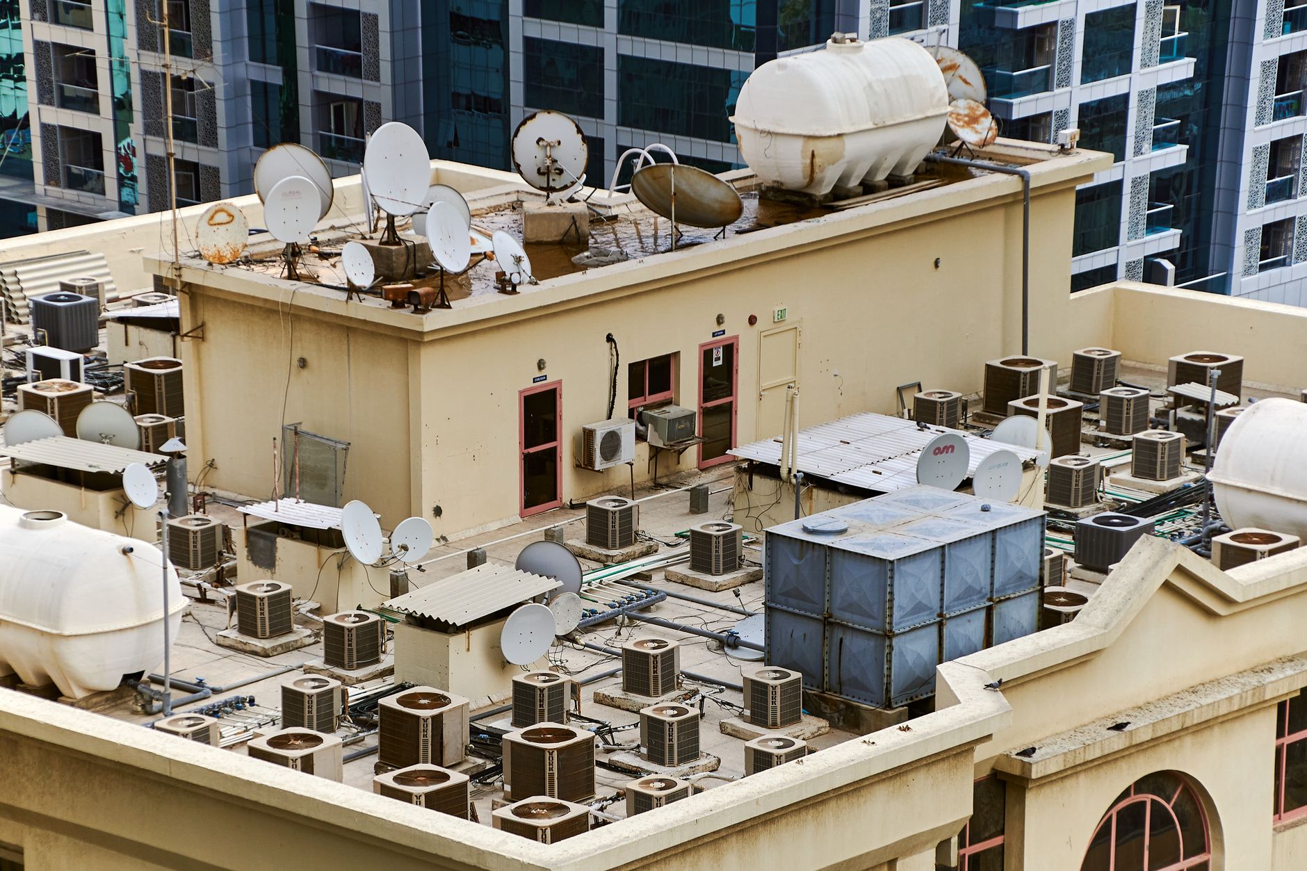 Several large HVAC units sit on the flat roof of a commercial building, representing the type of essential equipment that drones can inspect safely and efficiently.