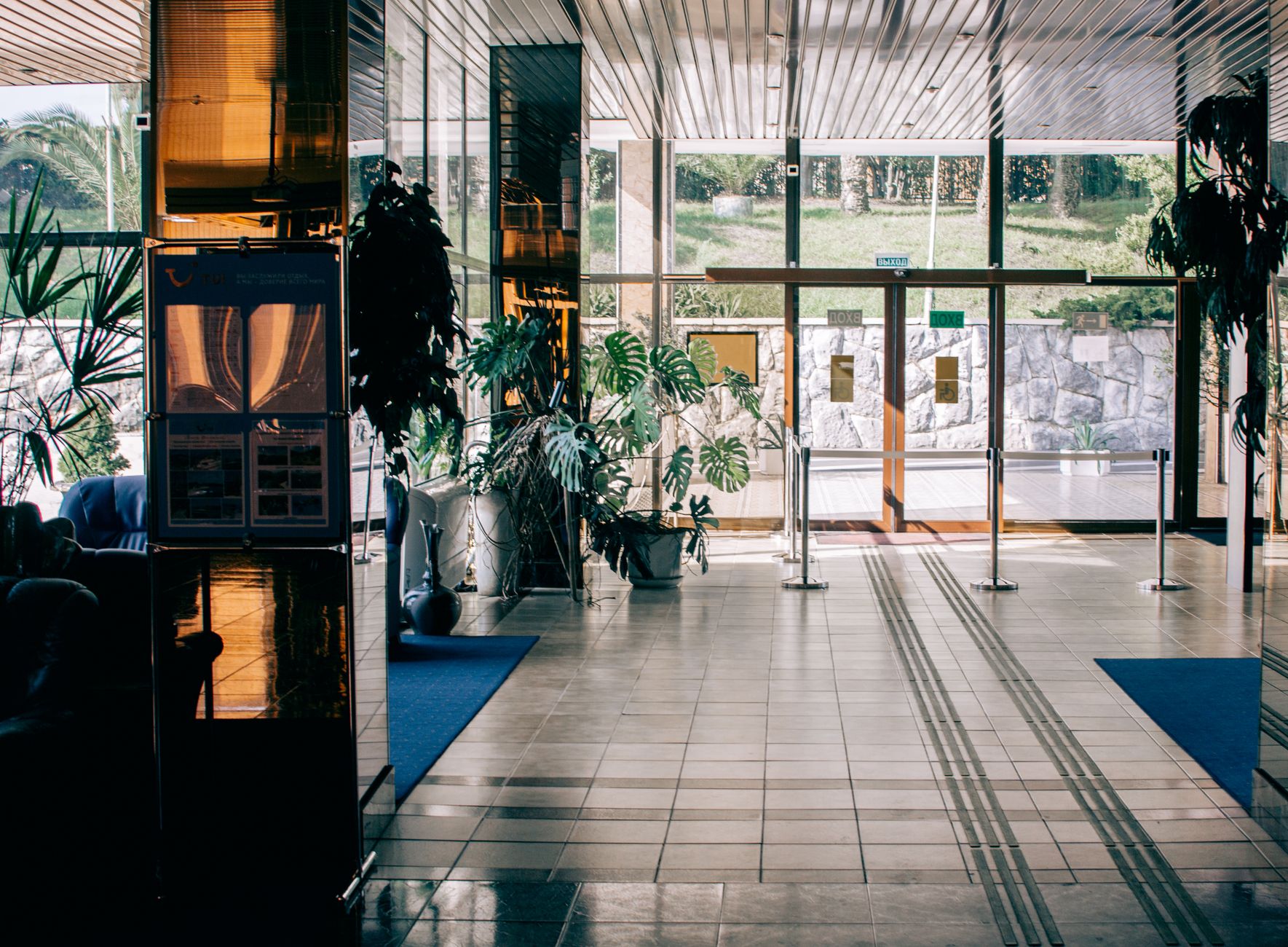 A bustling hospital lobby with staff, patients, and visitors moving about, showing the dynamic environment where cleaning robots must operate safely.