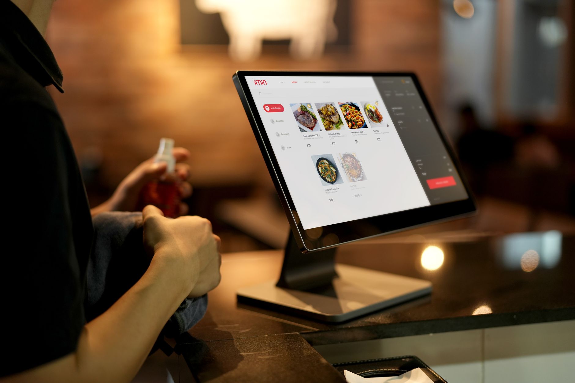 A close-up of a restaurant's point-of-sale screen where orders are entered, showing the technology that can be integrated with food service robots.