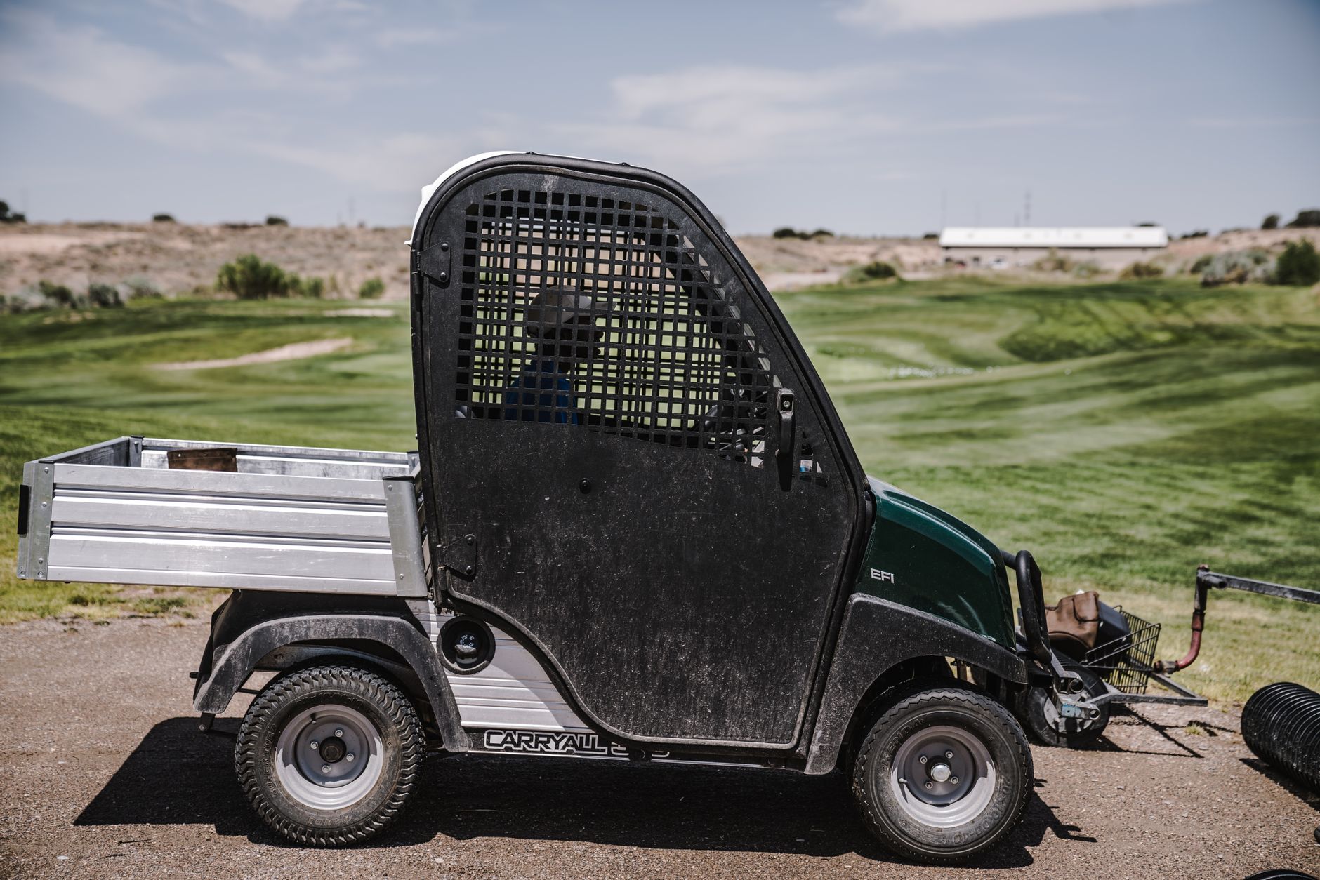 Cart path corridor shared by maintenance trucks and turf equipment