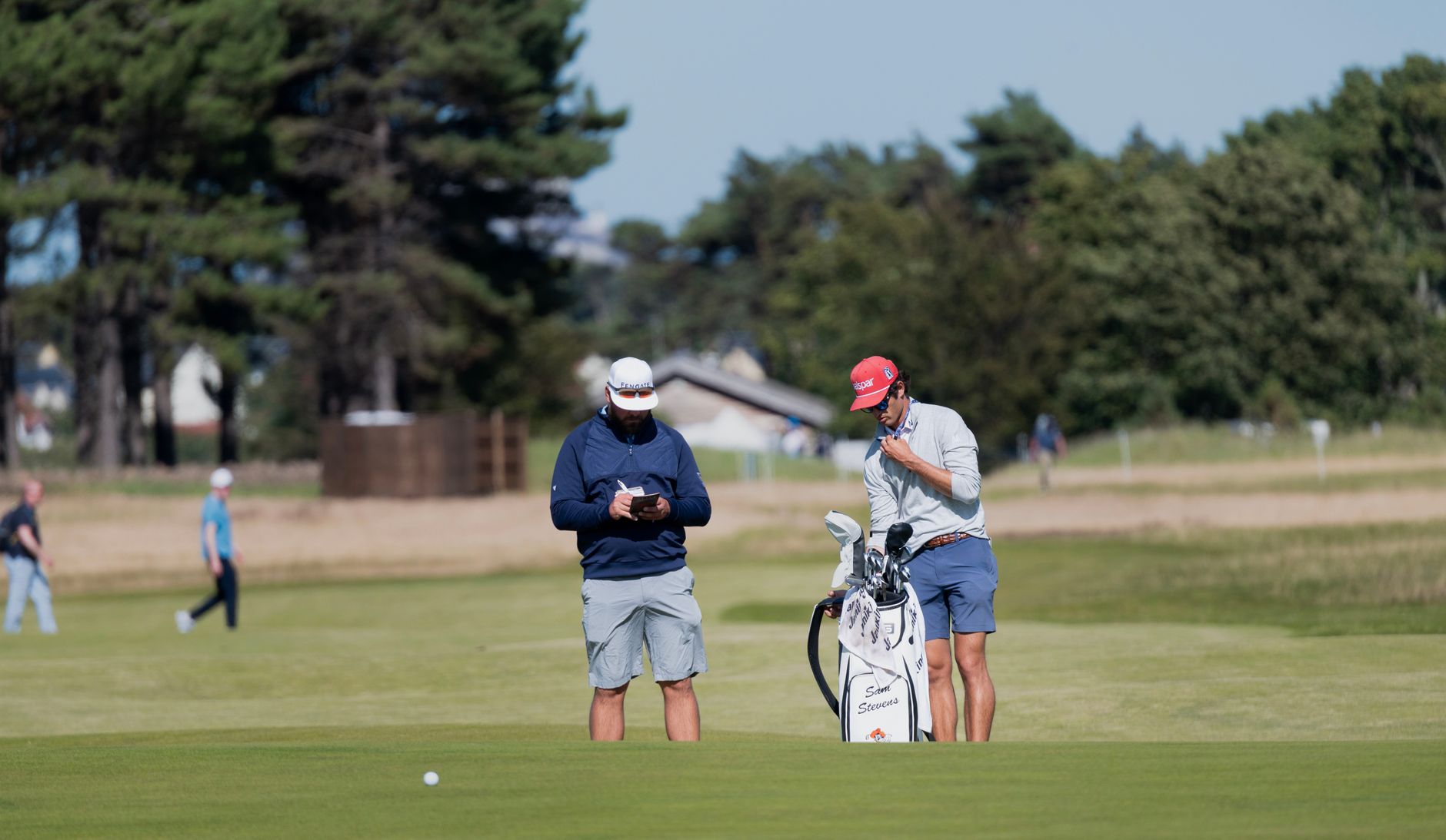 Golfers gathering near the clubhouse where daily course conditions are posted