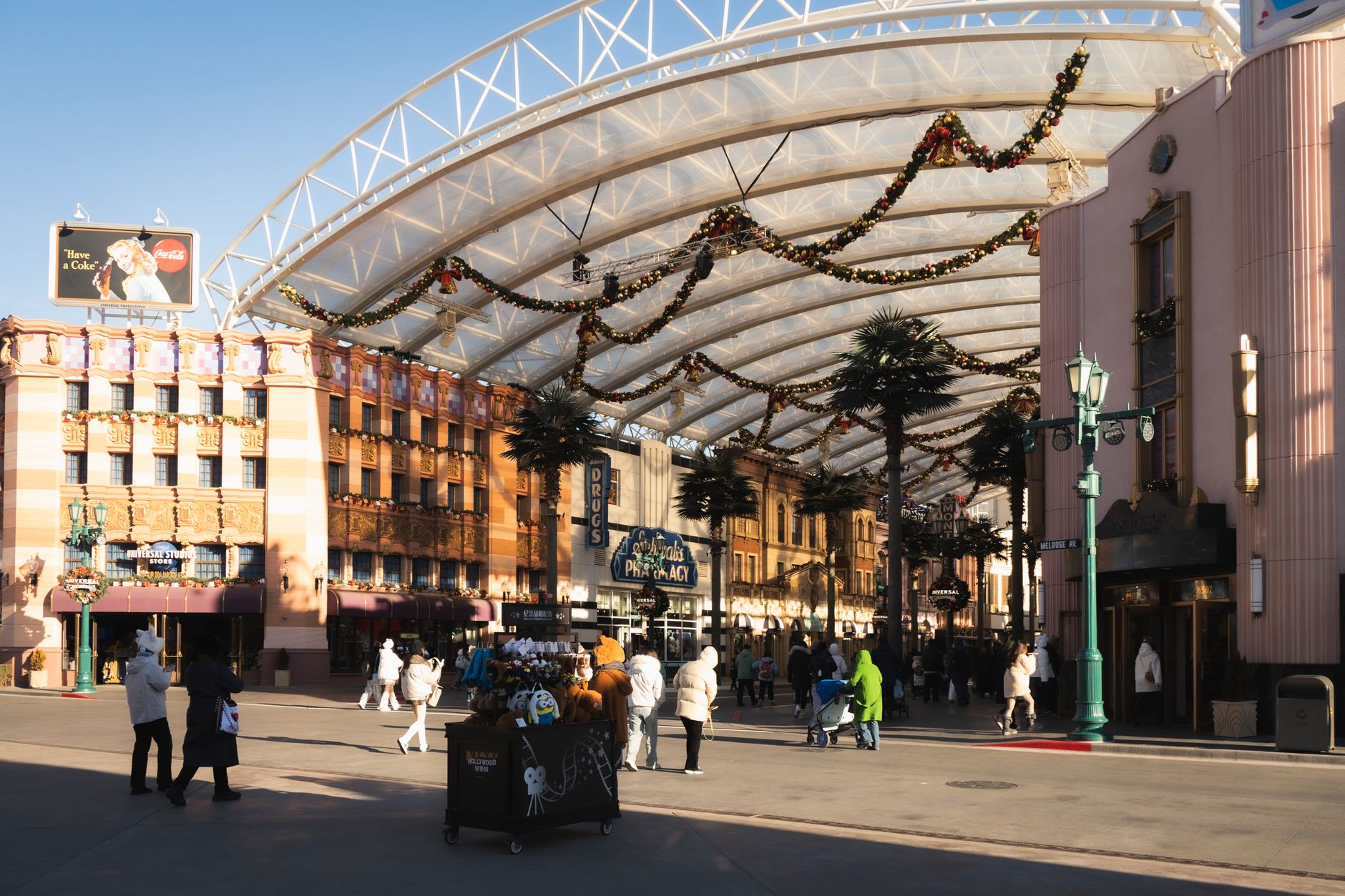 Visitors walking along a theme park promenade