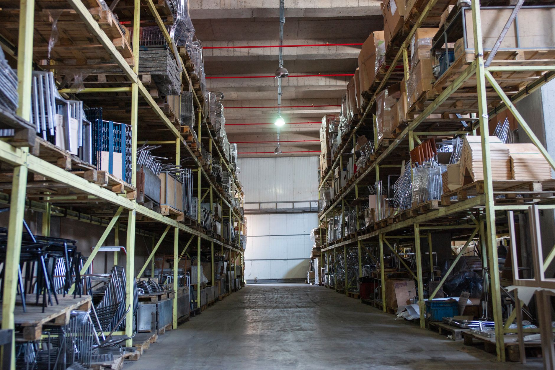 Tall, sturdy pallet racking in a warehouse, representing the heavy-load and vertical stacking capabilities of automated forklifts.