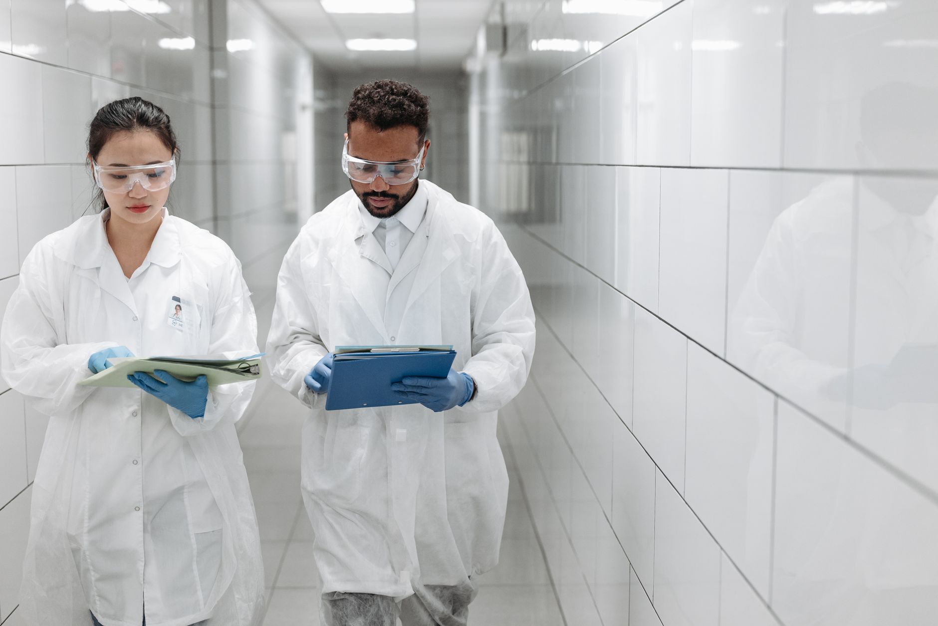 A long research building corridor where carts move between lab support areas and decontamination rooms.