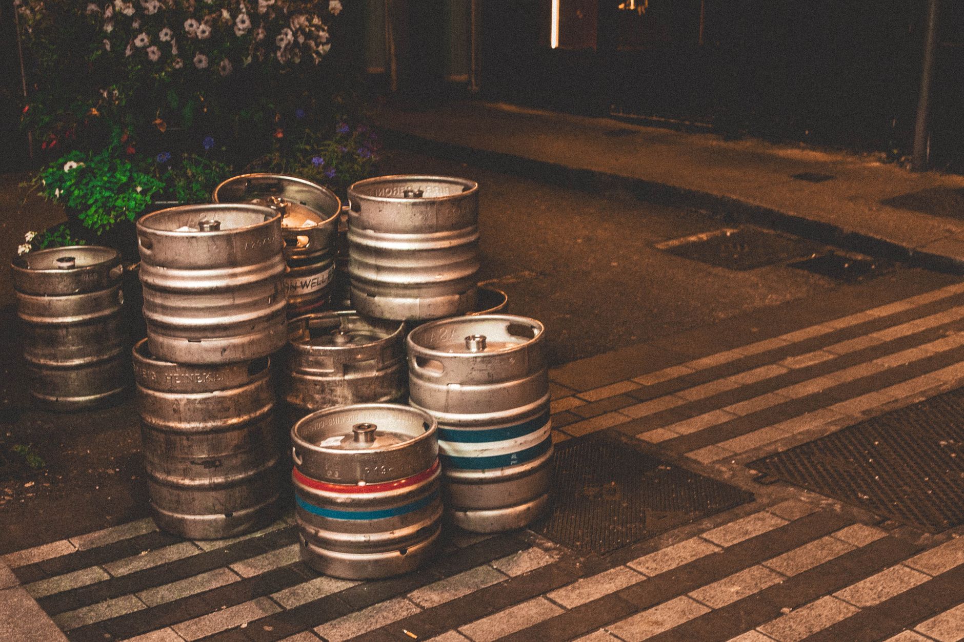 Stacked steel kegs representing loads that need secure restraint on carts.