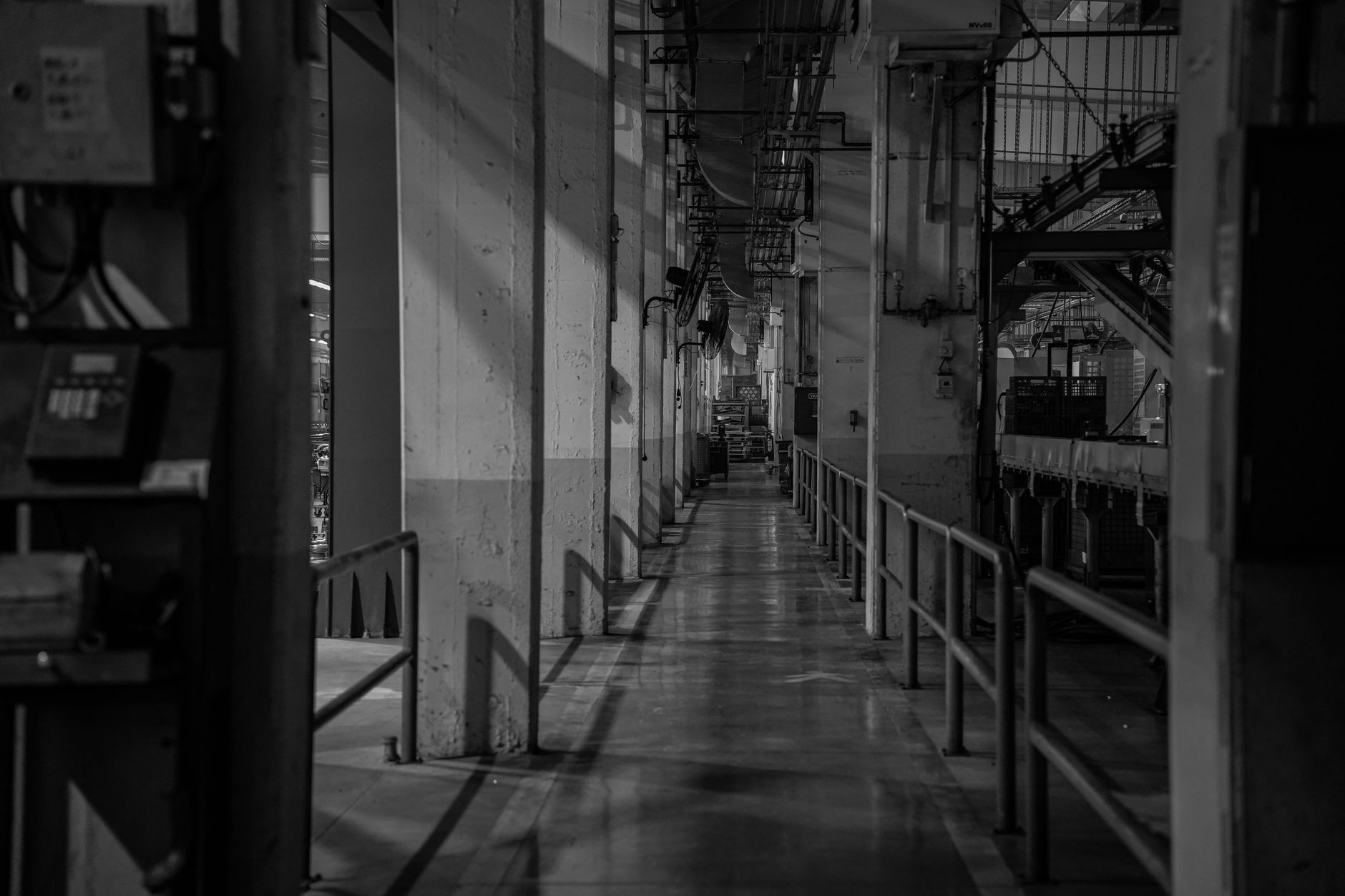 Narrow factory corridor where pedestrian and vehicle traffic must stay separated.