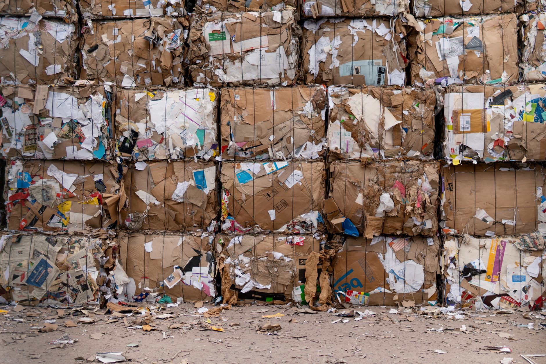 Stacked bales and bins in an industrial recycling area similar to mill scrap handling.