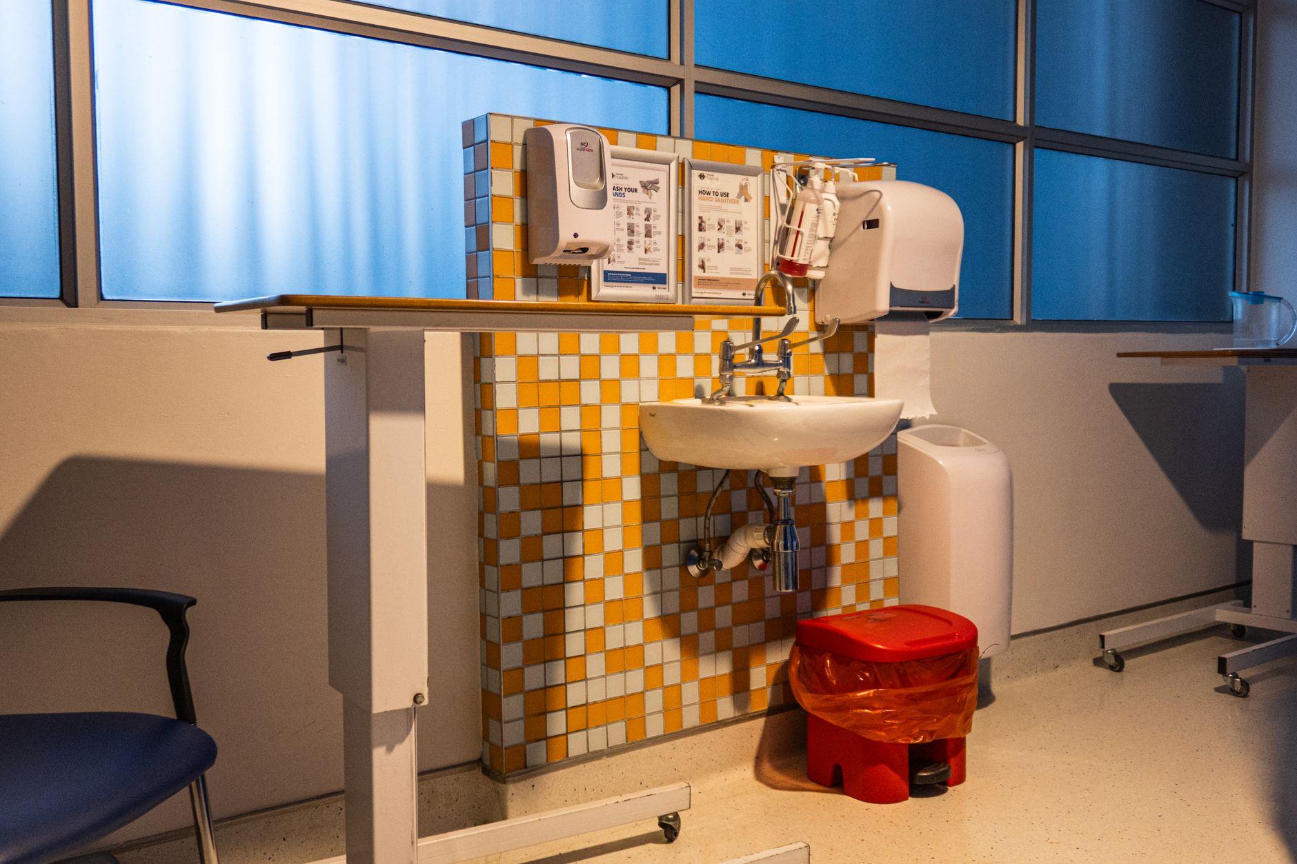 Clinical hygiene station at a zone boundary where contamination rules apply to cart traffic.