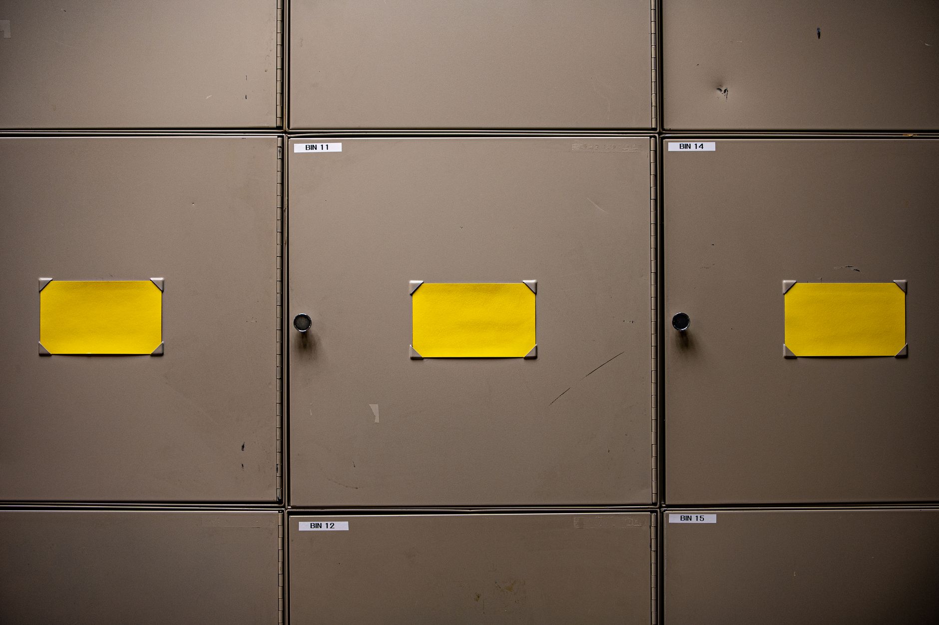 A labeled flammable liquids storage cabinet in an industrial shop, illustrating classified boundaries near coatings work.