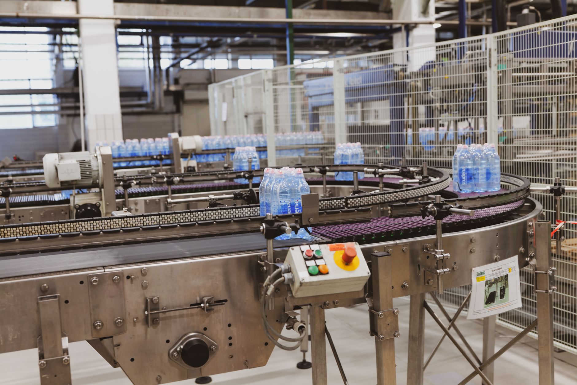 Finished goods moving down a packaging line, illustrating the end-of-line automation process that AMRs support.