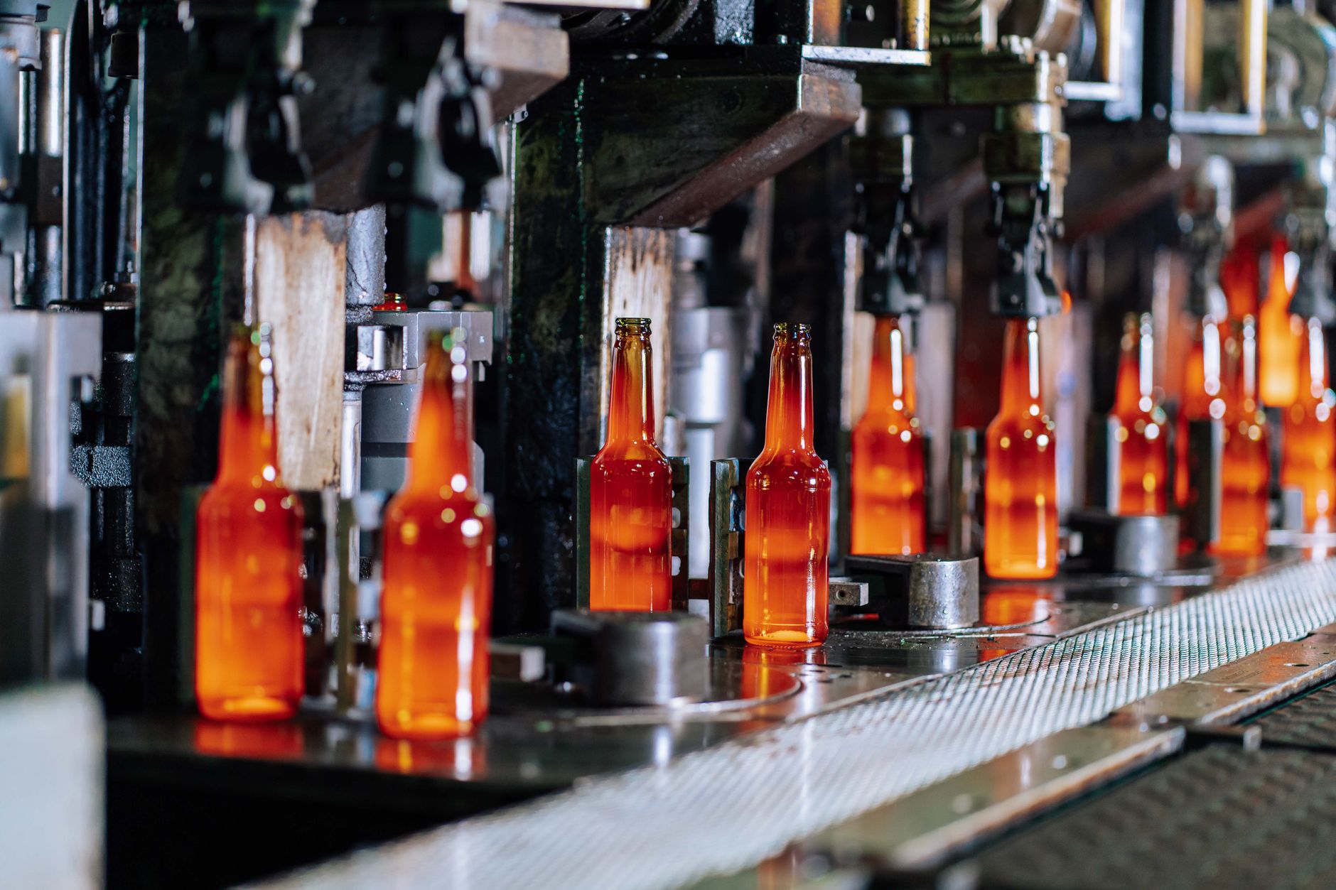 Interior of a window manufacturing plant with long aisles where glass racks move between production stations.