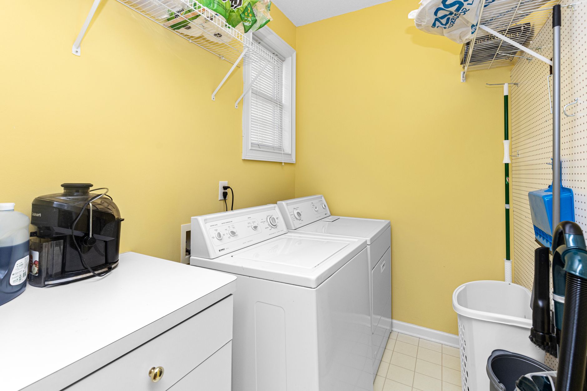 A neatly organized housekeeping supply closet on a guest floor, showing the kind of handoff point that makes linen-loop automation practical.