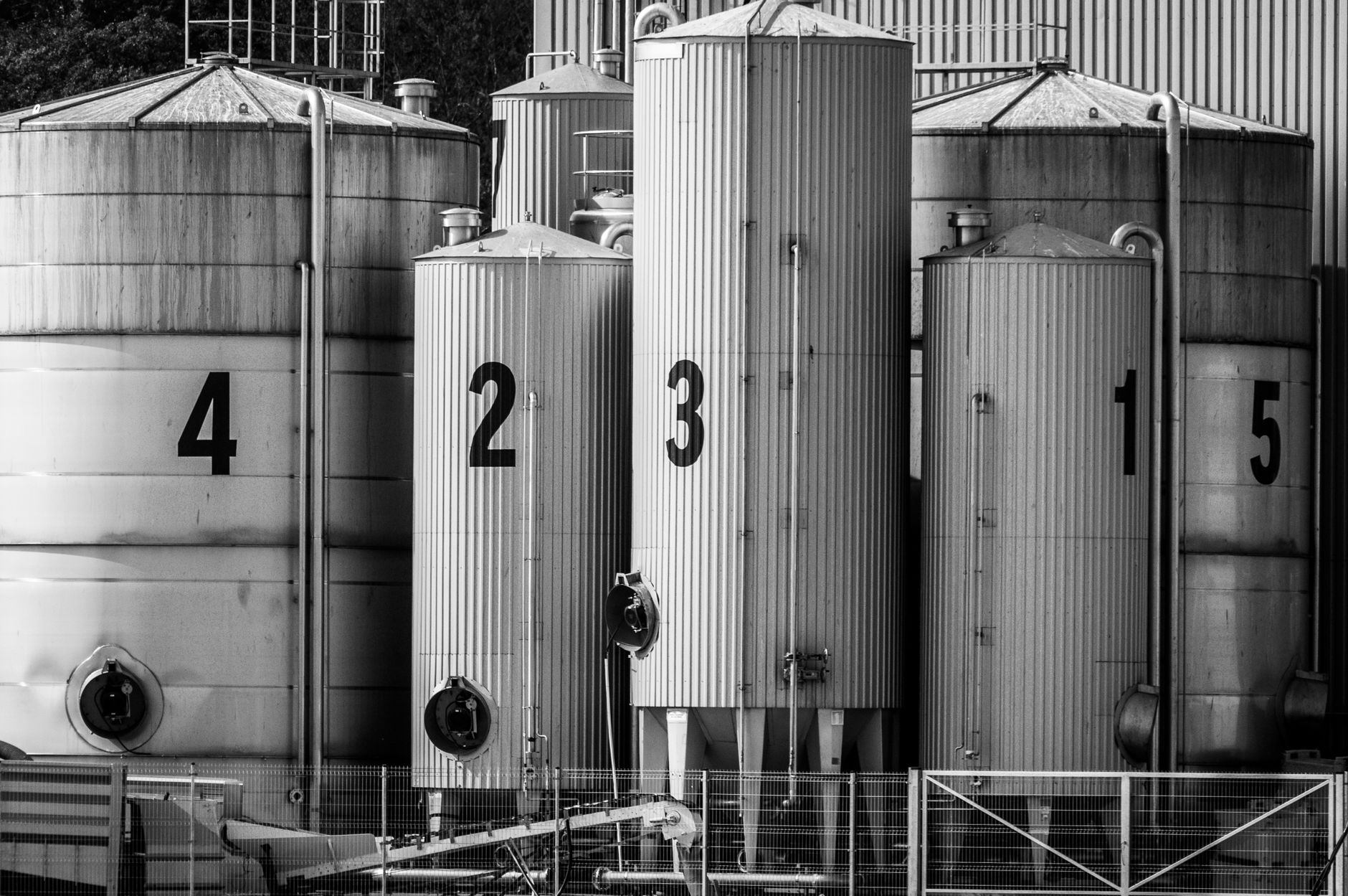 Cosmetics manufacturing area with industrial drums and clean production surroundings.
