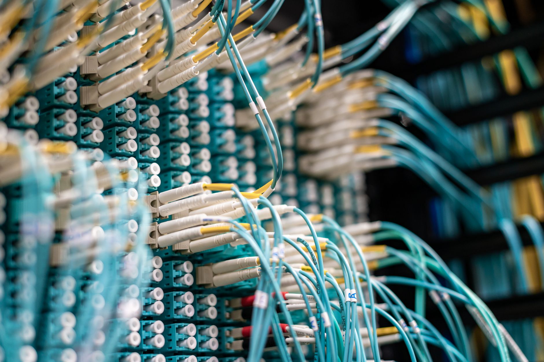 A network server rack with organized cables, representing the technical integration between AMRs and a warehouse management system (WMS).