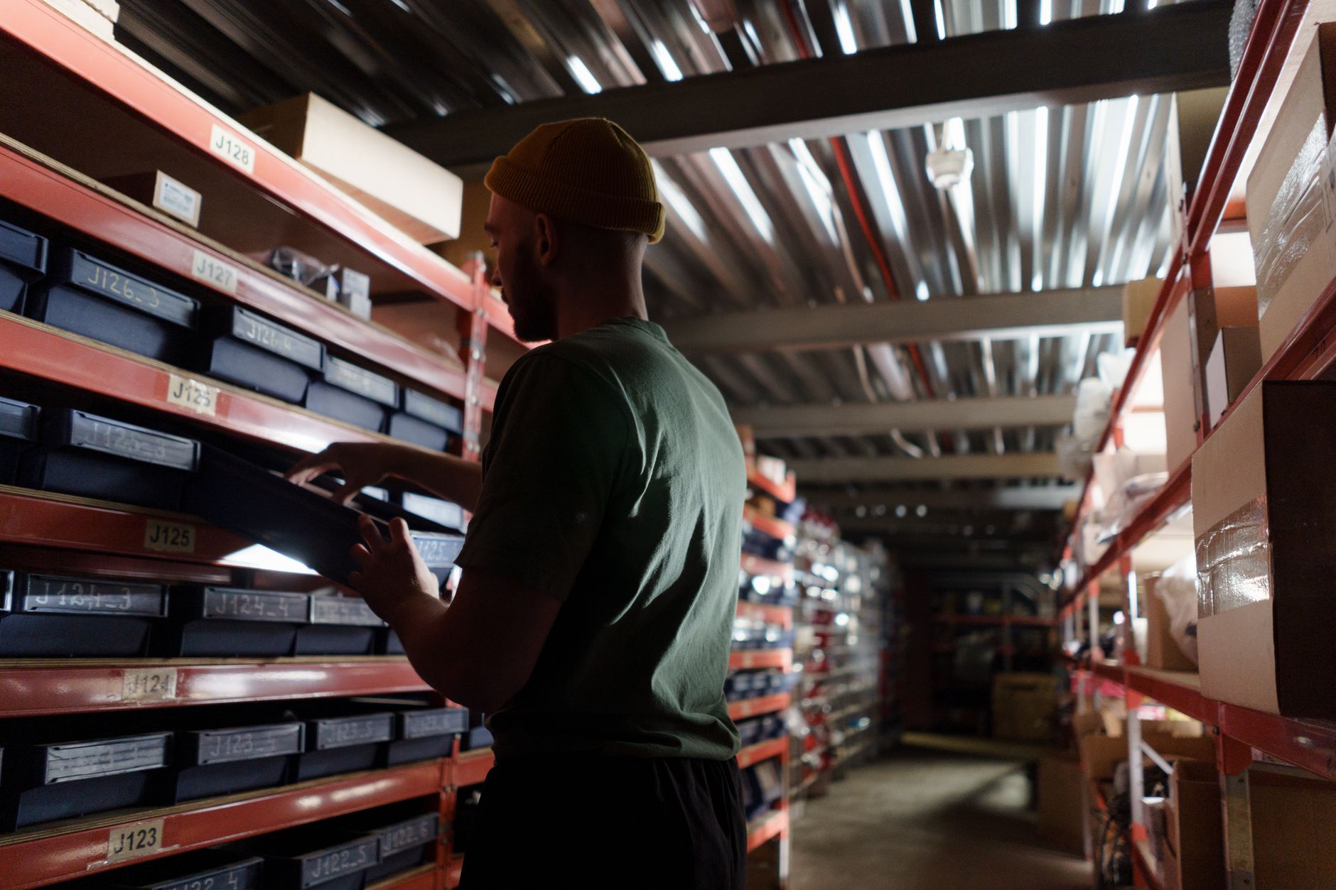 A quiet, well-lit retail stockroom at night, with organized shelves ready for an automated inventory count.