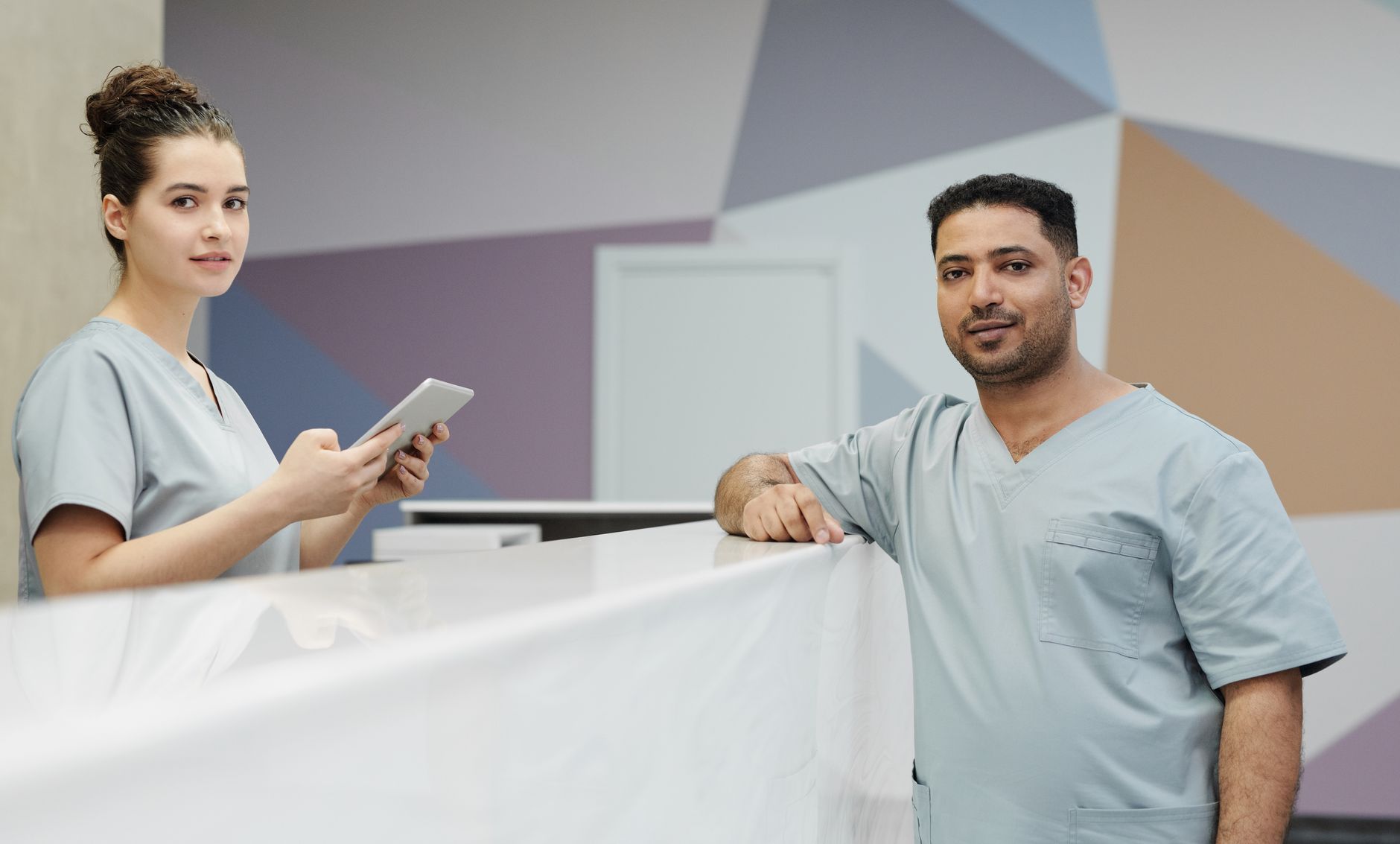 A busy nursing station where staff coordinate equipment requests and PAR closet levels.