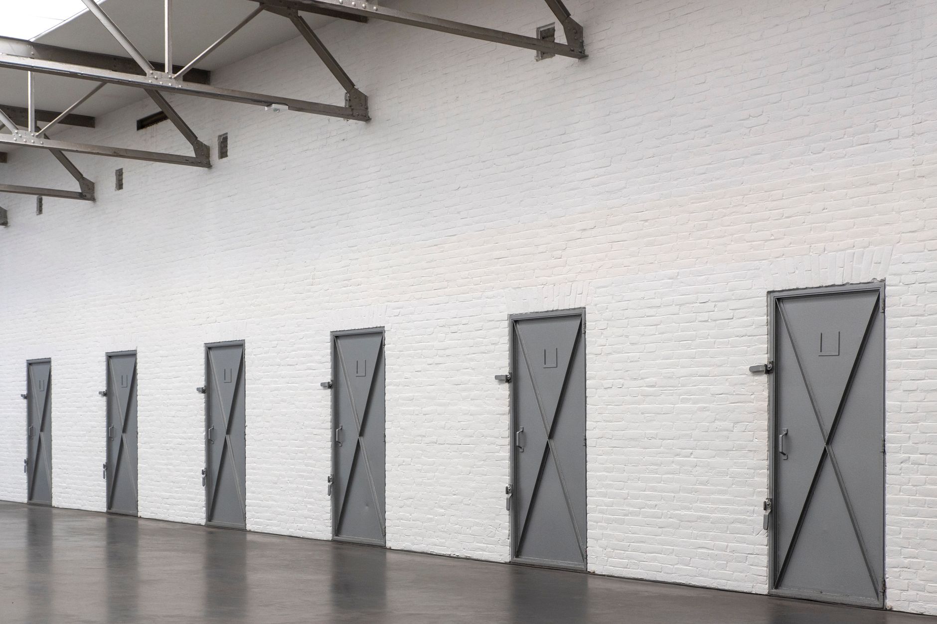 A controlled corridor with heavy doors where cart moves need supervised handoffs.