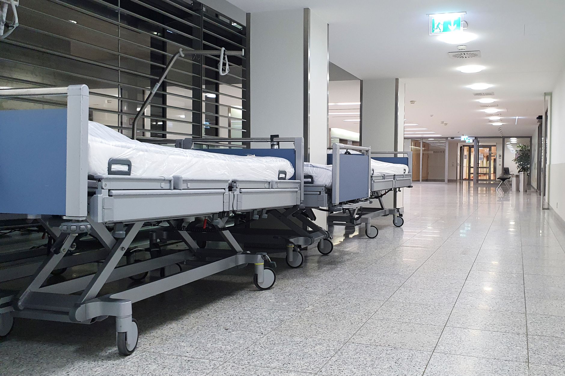 A quiet hospital service corridor suggests the controlled route an oxygen cylinder run must follow between storage and clinical floors.