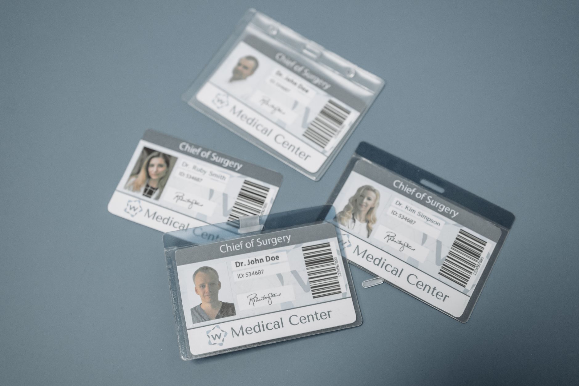 A hospital employee using an identification badge to enter a restricted clinical laboratory area.