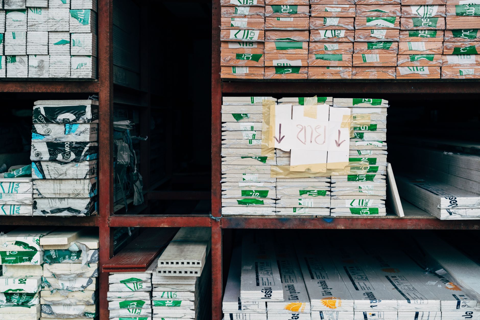 Shelves of organized lab and facility supplies, illustrating the repetitive campus restock loops that suit standardized AMR transport.