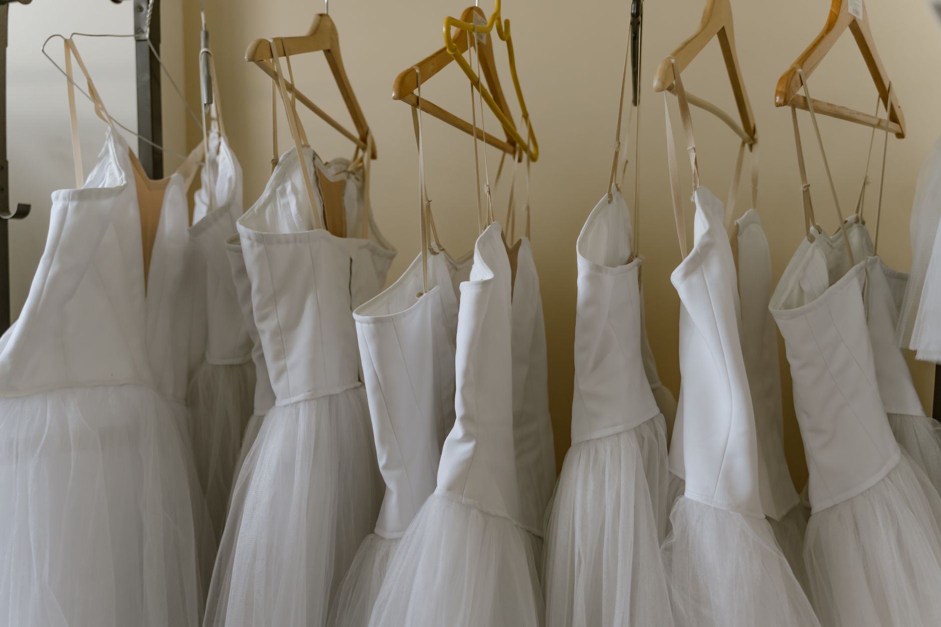 Wardrobe racks that AMRs must move without snagging garment bags.