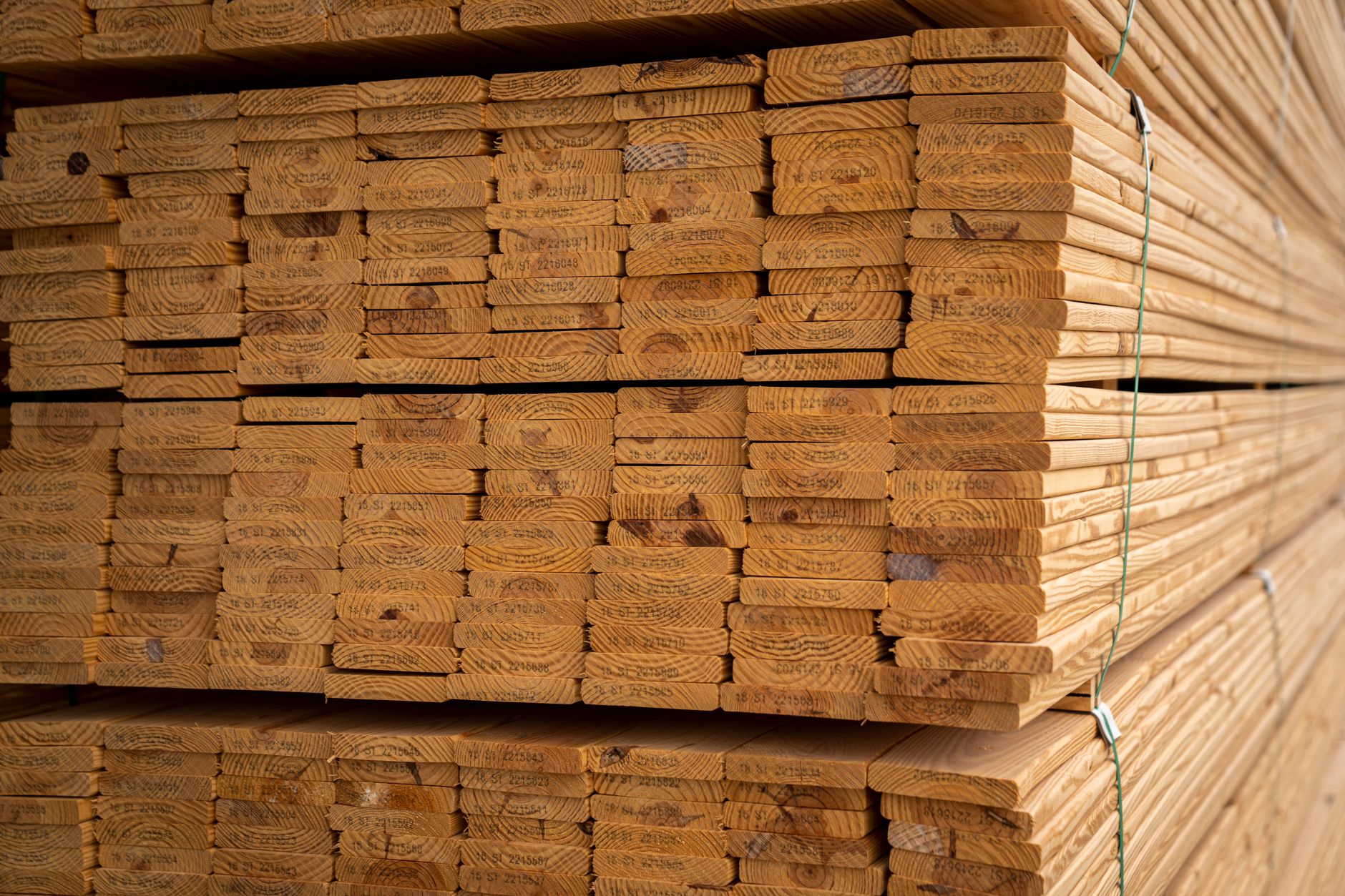 Cut furniture panels are stacked in organized batches awaiting their next production step.