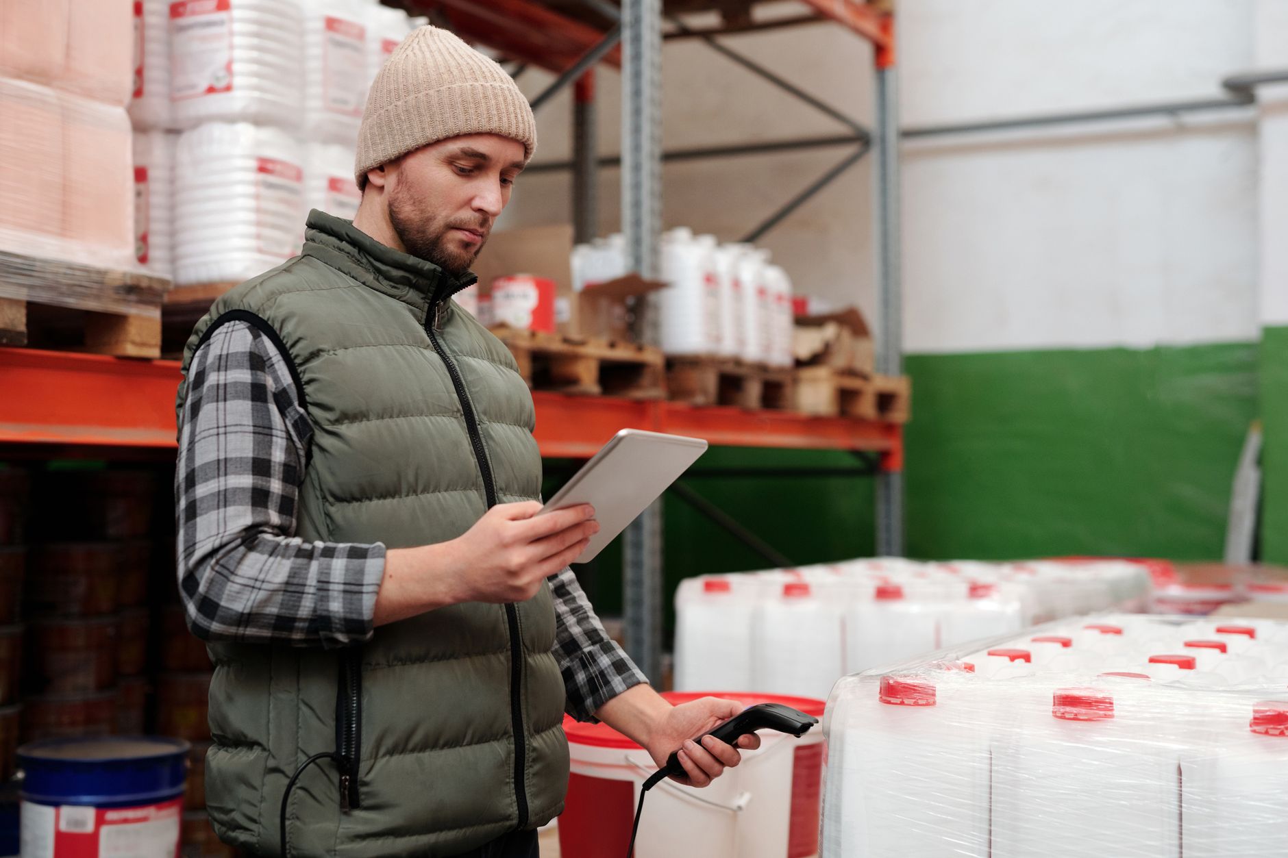 A close-up of a warehouse worker using a handheld scanner on a package, highlighting the focus on accuracy and efficiency.