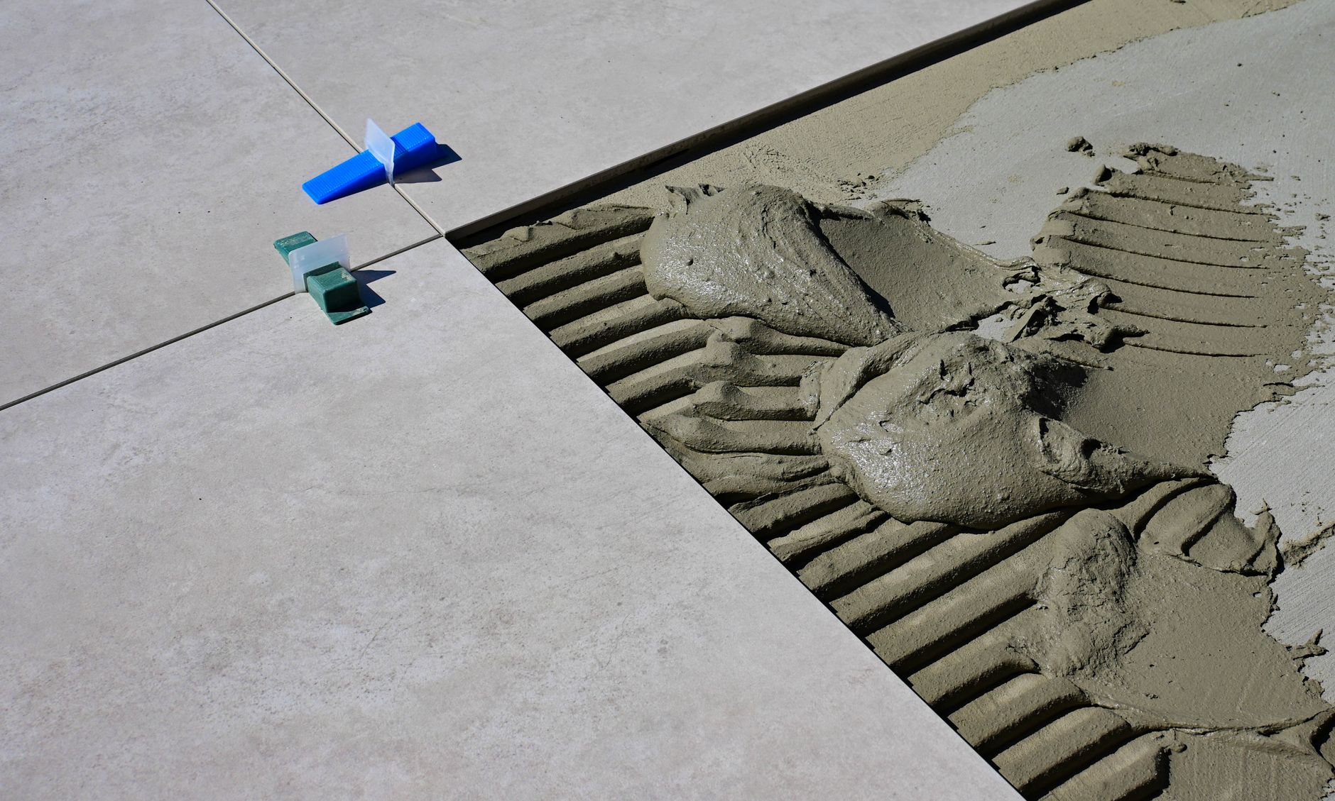 A wide view of a concrete warehouse floor showing the pattern of control joints that can be an obstacle for robots.