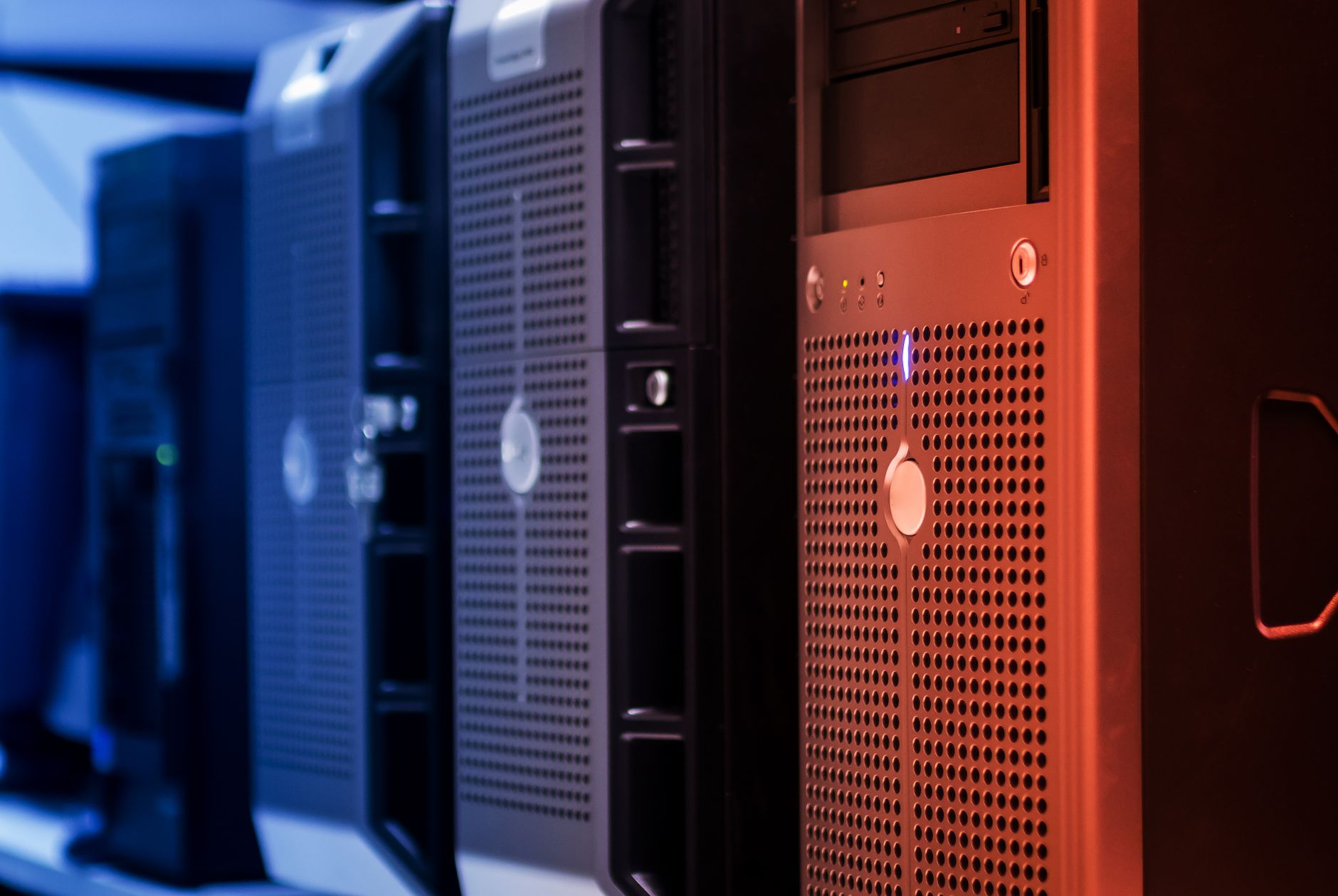 A view down a row of network server racks with blinking lights, representing the robust digital infrastructure needed to run a robot fleet.