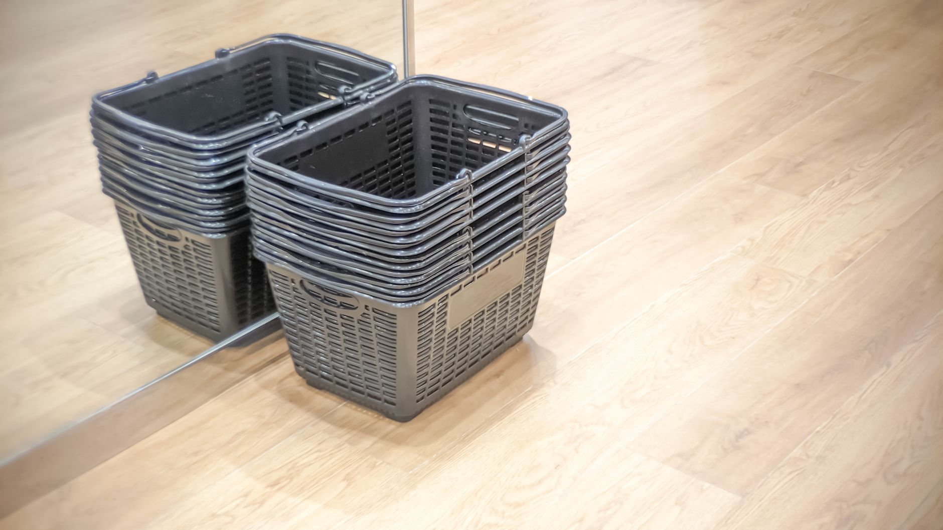 A low-angle view of a gleaming, clean floor in a large retail store, reflecting the overhead lights after a thorough cleaning.