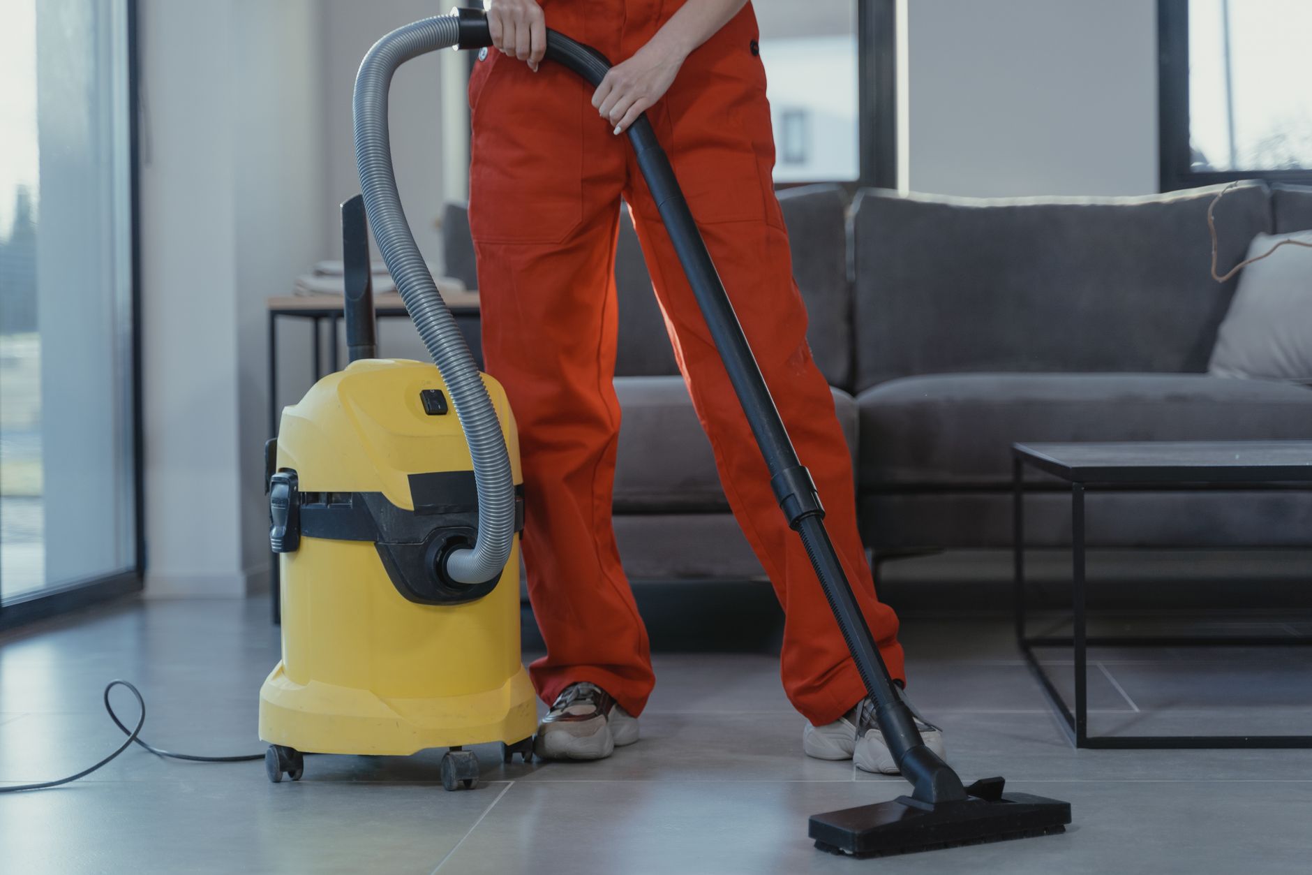 A member of a janitorial team performing detailed cleaning on a high-touch surface, representing higher-value work redeployed from floor scrubbing.