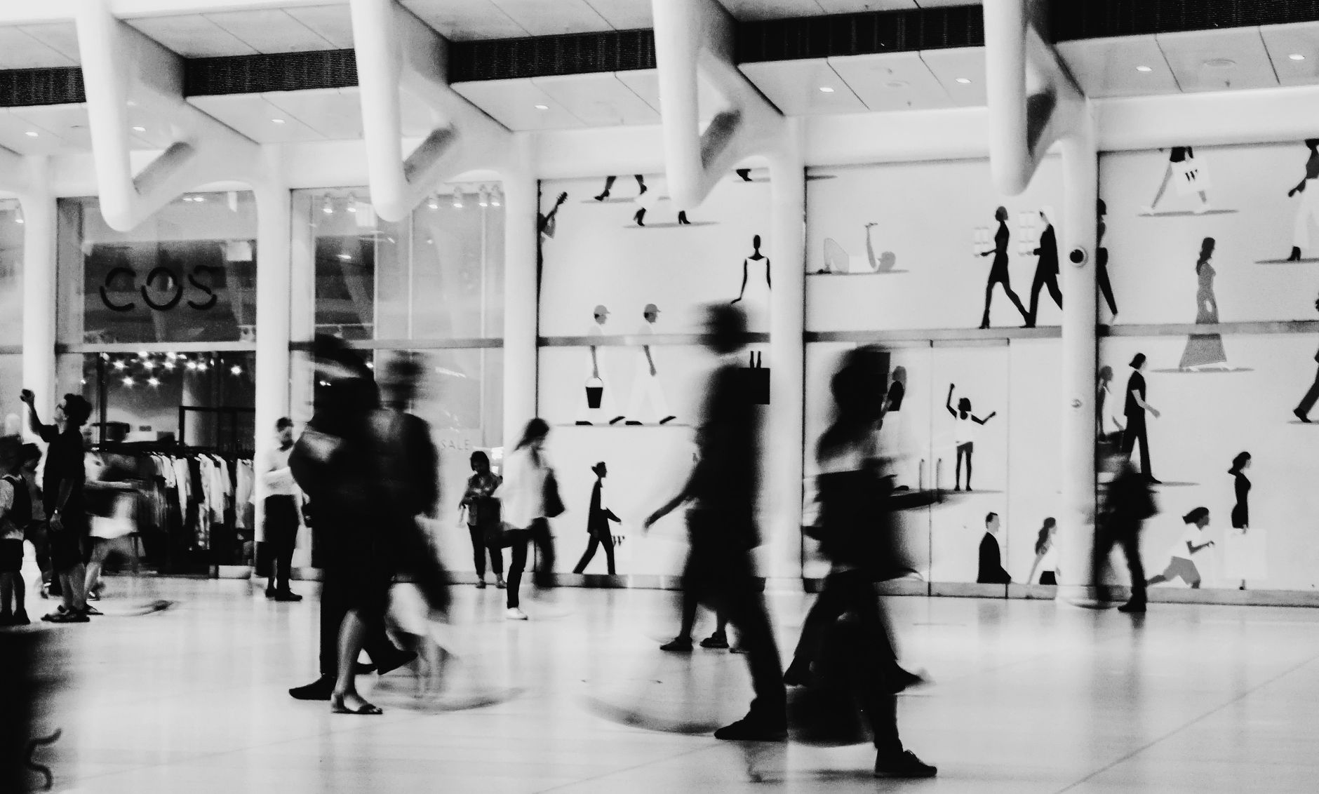 People walking through a crowded space, representing the dynamic and unpredictable environment a bussing robot must safely navigate.