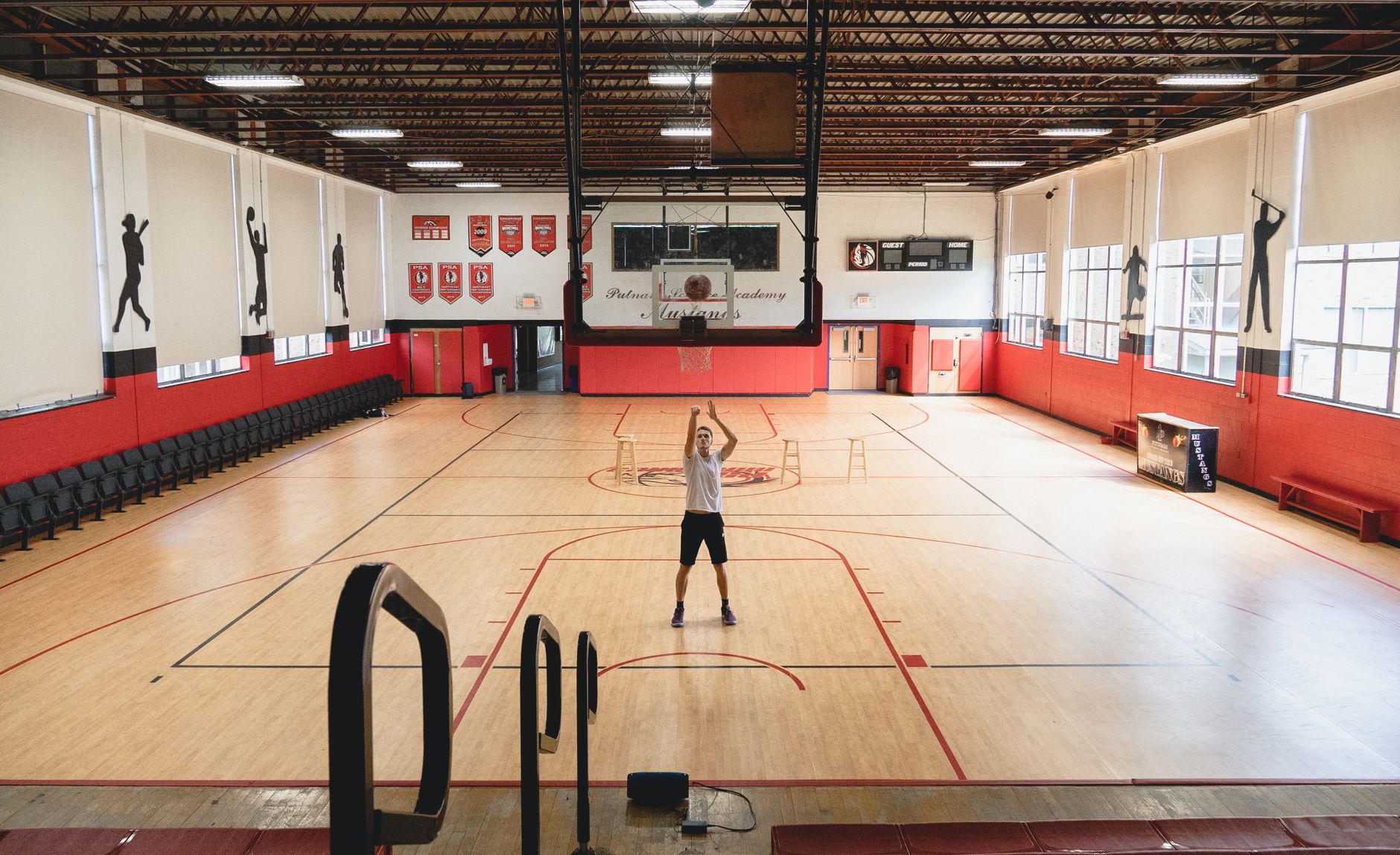 A wide, clean expanse of flooring in a modern fitness center, ready for the morning members.