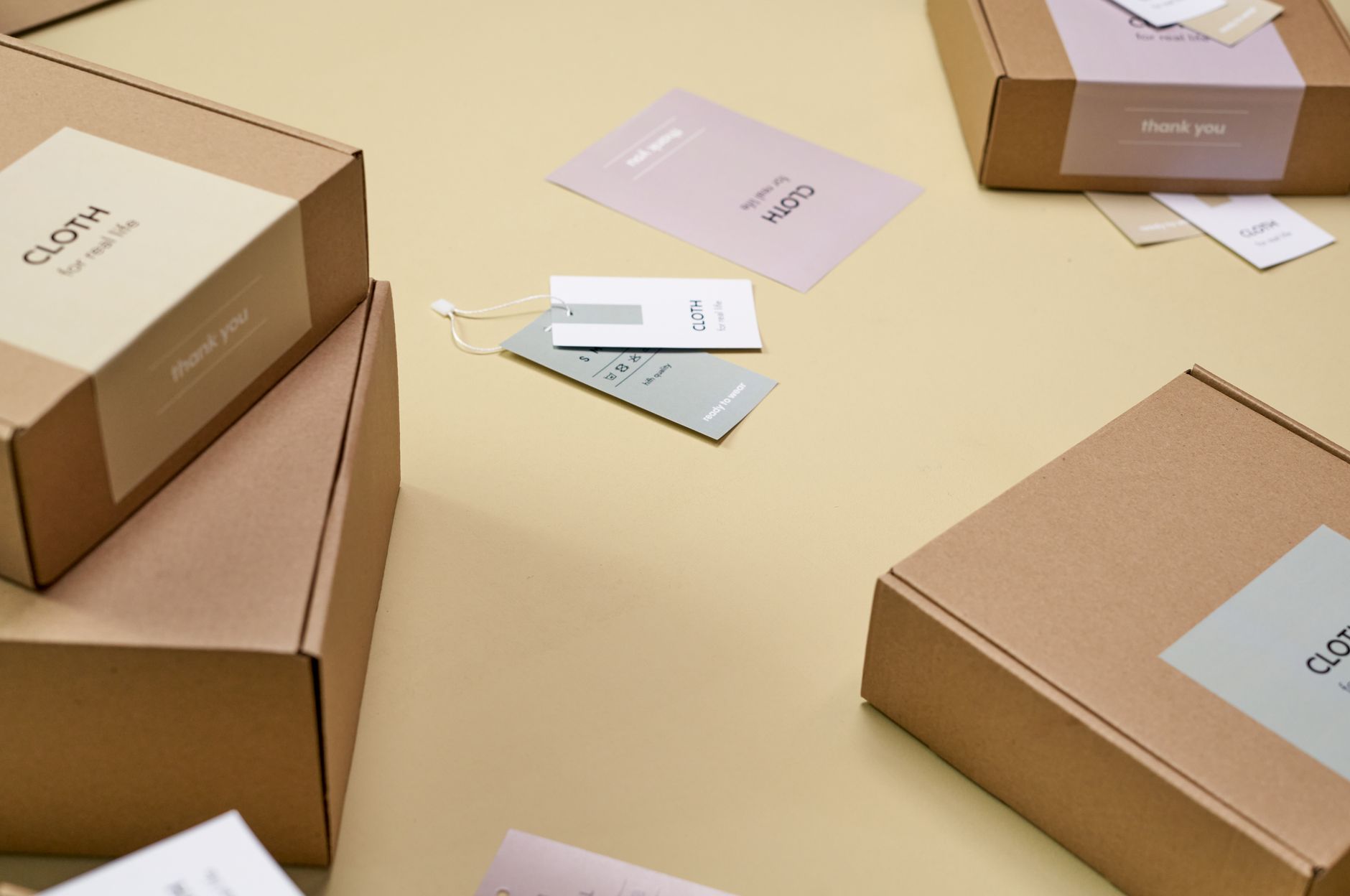A close-up view of a white RFID sticker affixed to the side of a cardboard box in a stockroom.