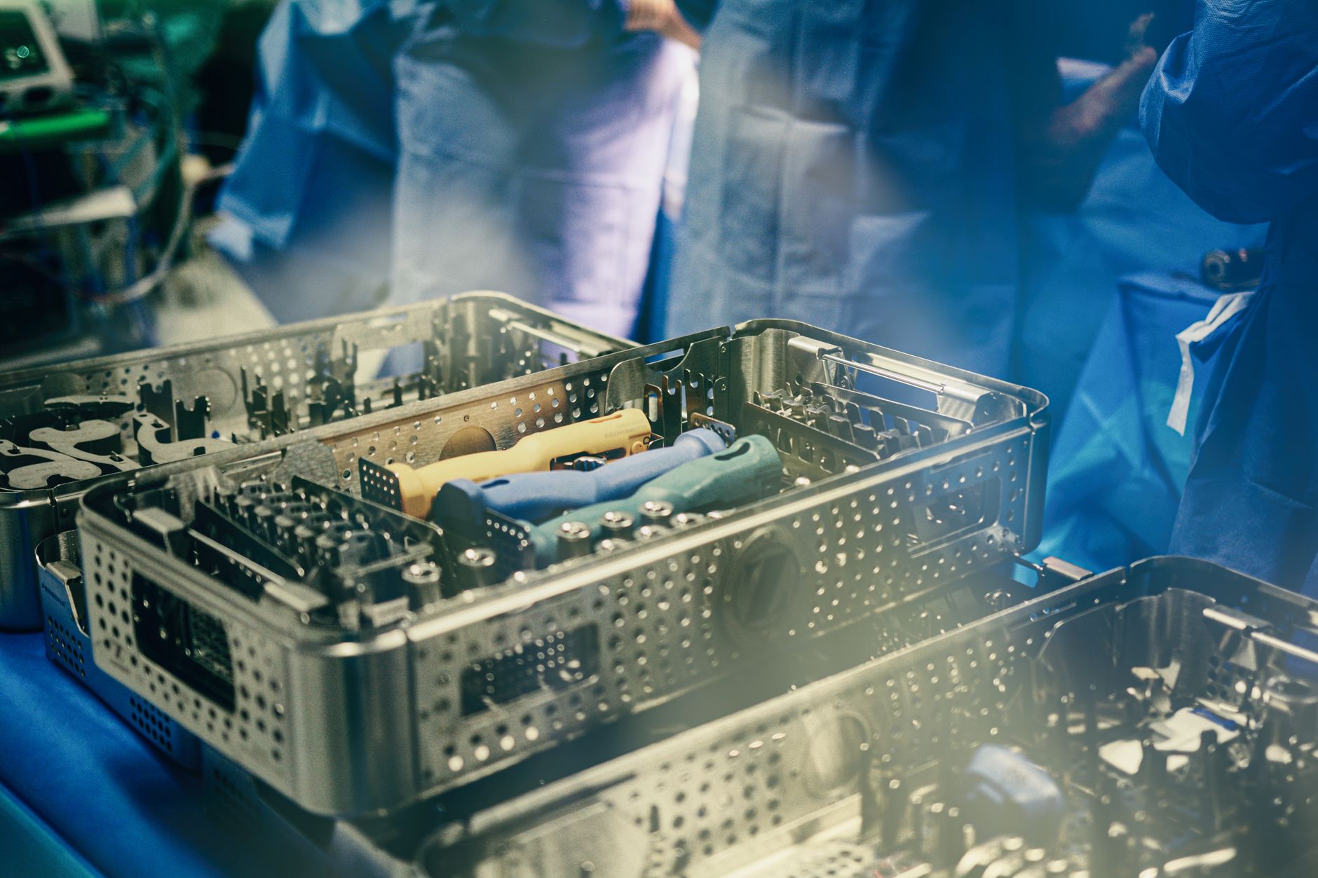 A tray of complex, sterilized surgical instruments lies ready, illustrating the skilled and essential work of Sterile Processing Department technicians.