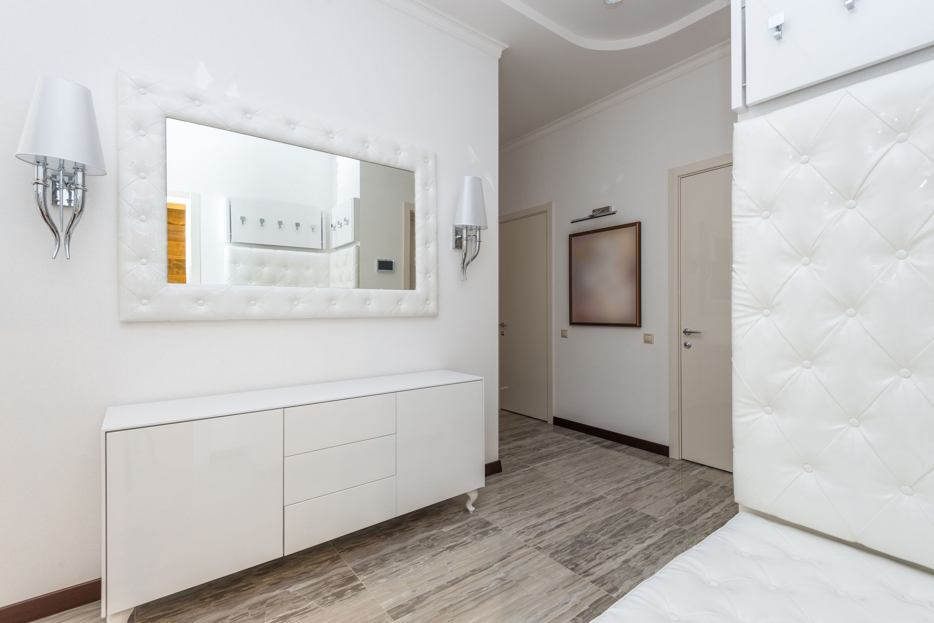 A clean, well-lit, empty hallway in a modern apartment building, representing an efficiently managed residential space.