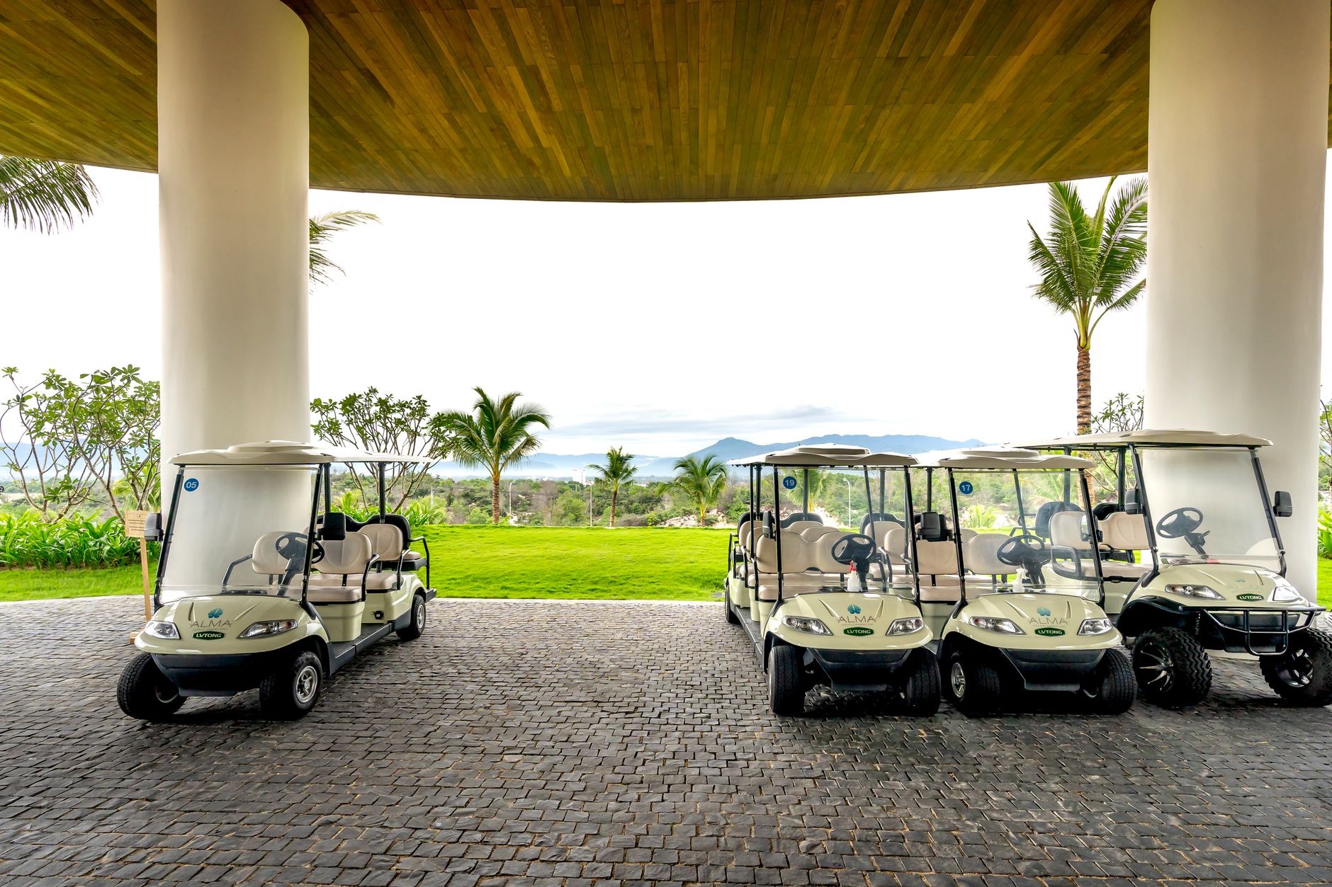 Stone patio seating area beside a golf clubhouse.