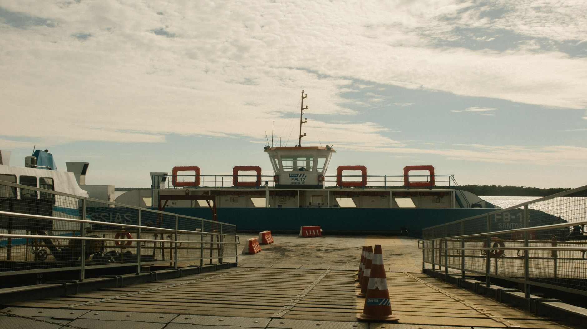 Passengers move through a ferry boarding gate as the next sailing approaches.