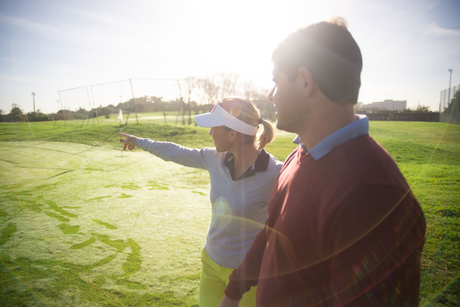 Golfers approaching a green during a best ball low-score hunt on a reachable hole.