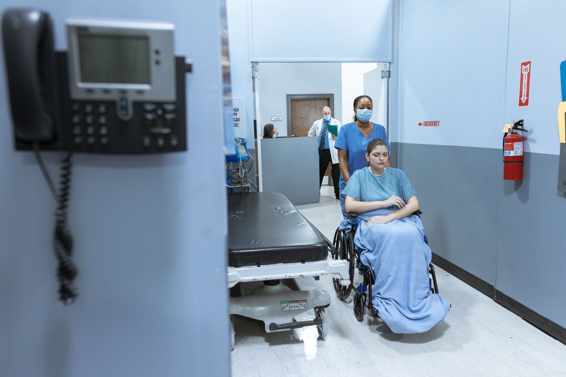 A bustling hospital corridor with people and equipment, an ideal environment for vision-based or hybrid AMR navigation to adapt to constant changes.