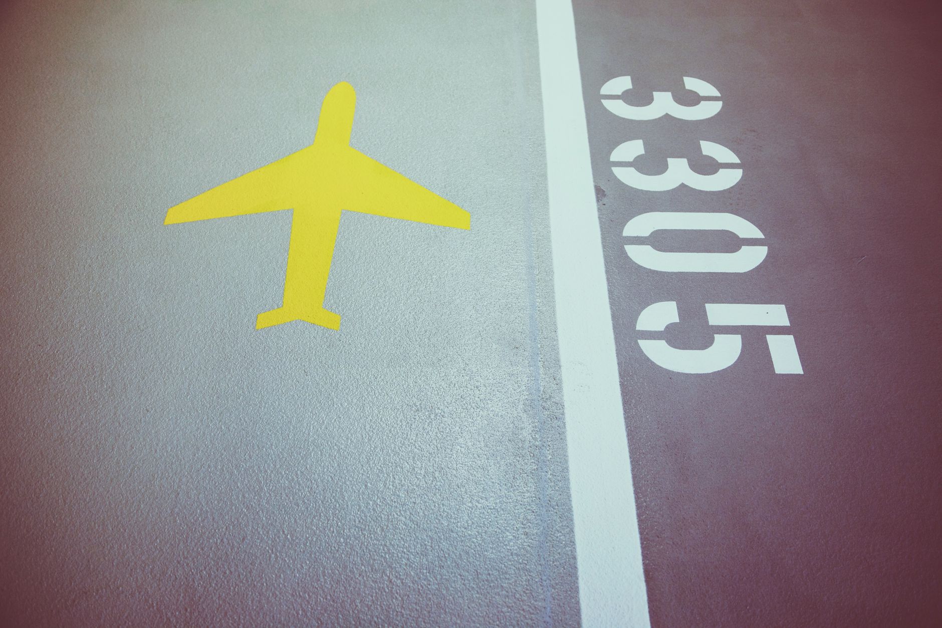 A close-up view of the textured surface of an airport runway, highlighting the environment where foreign object debris must be detected.