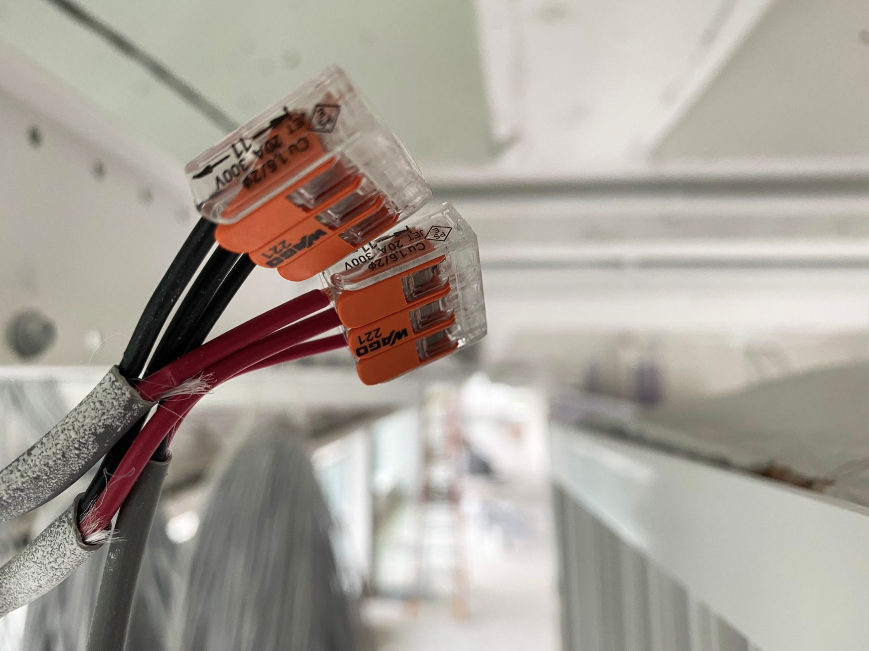 A technician inspects electrical connectors and component details before approving a spare-part match.
