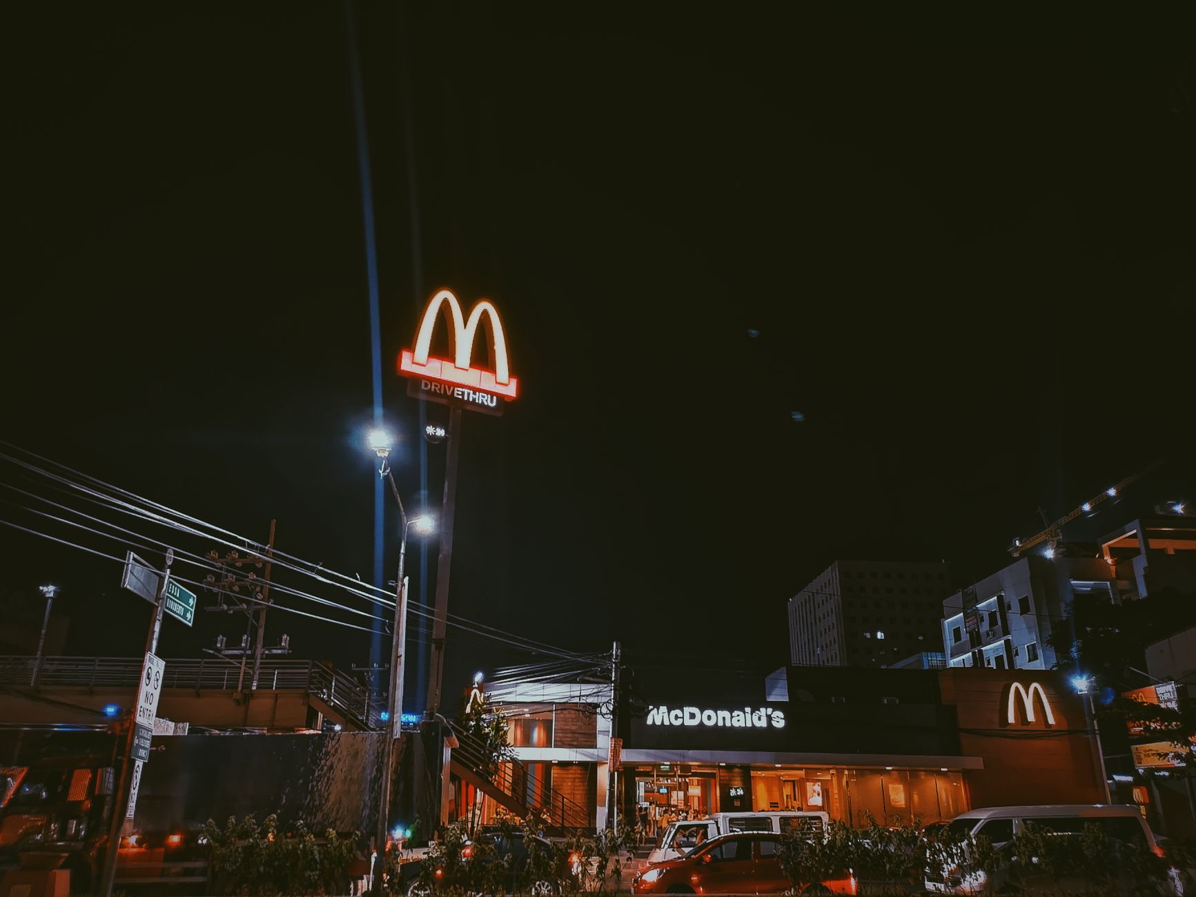 A car is illuminated at a Burger King drive-thru window at night, representing the QSR industry's focus on speed and efficiency.